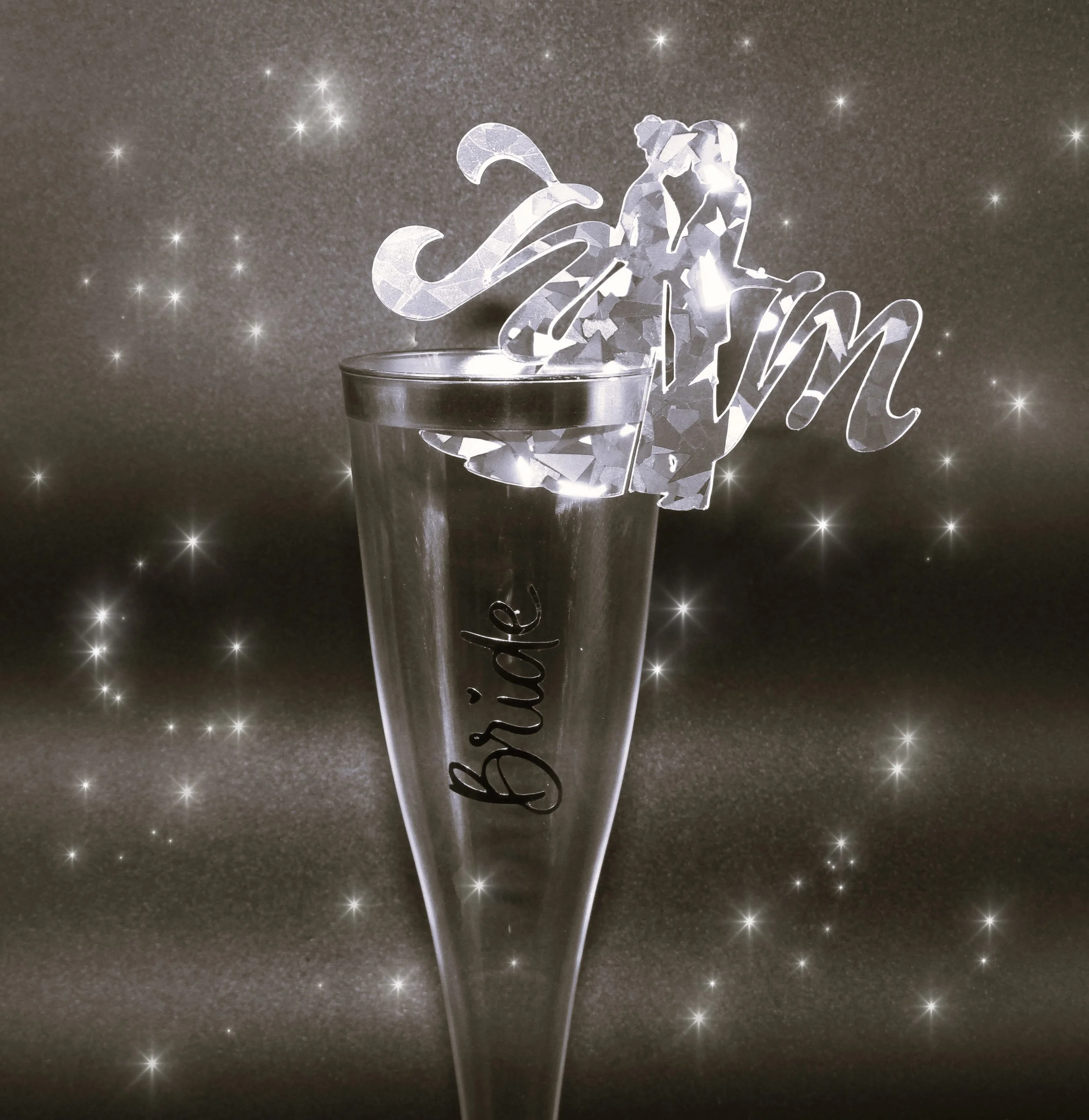 Flute Toppers!
These wedding flute toppers are perfect for adding a touch of sparkle to your flute glasses, they are crafted in silver holographic card. The toppers feature the bride & groom with initials, wedding dress, flute glasses, and wedding be