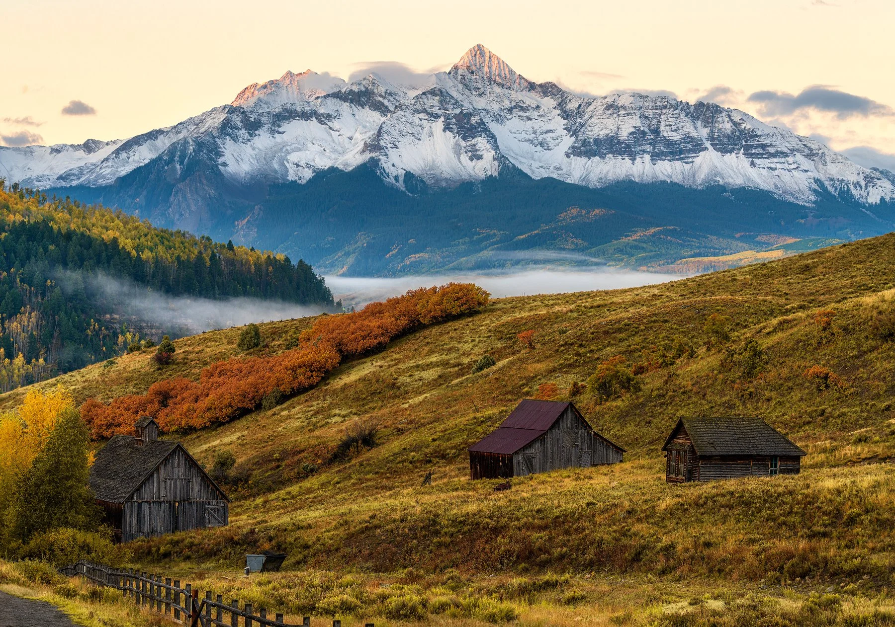 A closer look at some old buildings and the distant Wilson Peak during a fresh snow during one spectacular fall morning