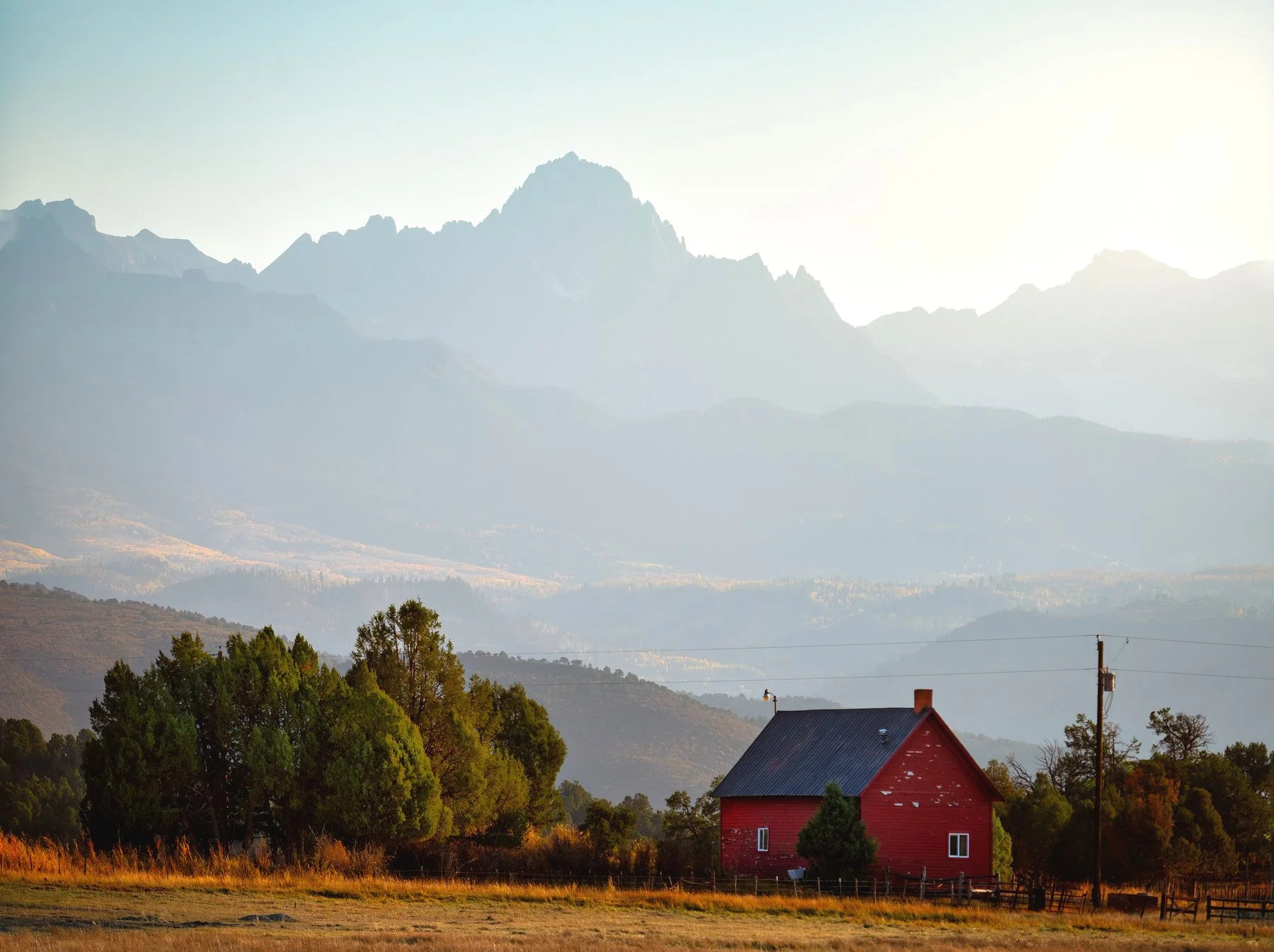 Mt. Sneffels nearly 15 miles in the distance towering over this old house
