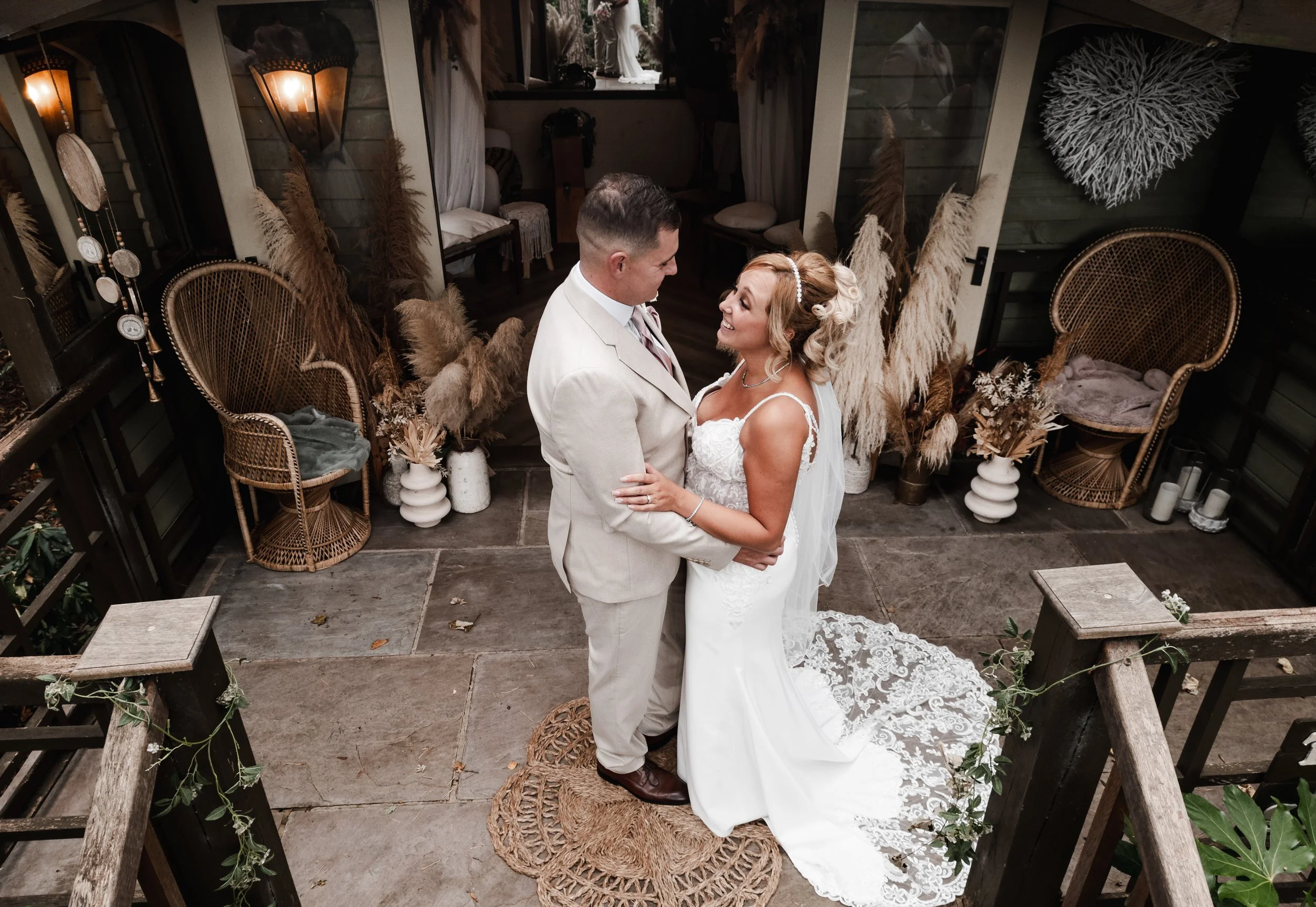The Love Shack - groom and bride in wedding attire, looking at each other and smiling.