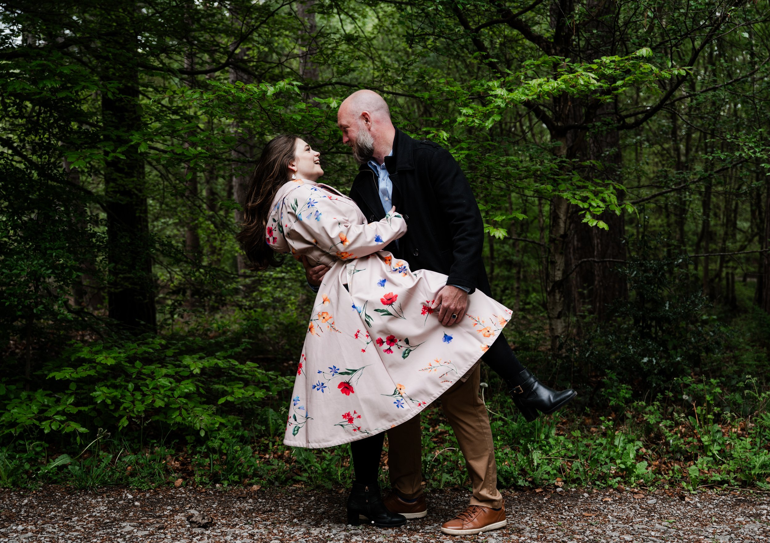 Delamere Forest Engagement shoot - man and woman embraced while he holds up her leg and they smile at each other. 