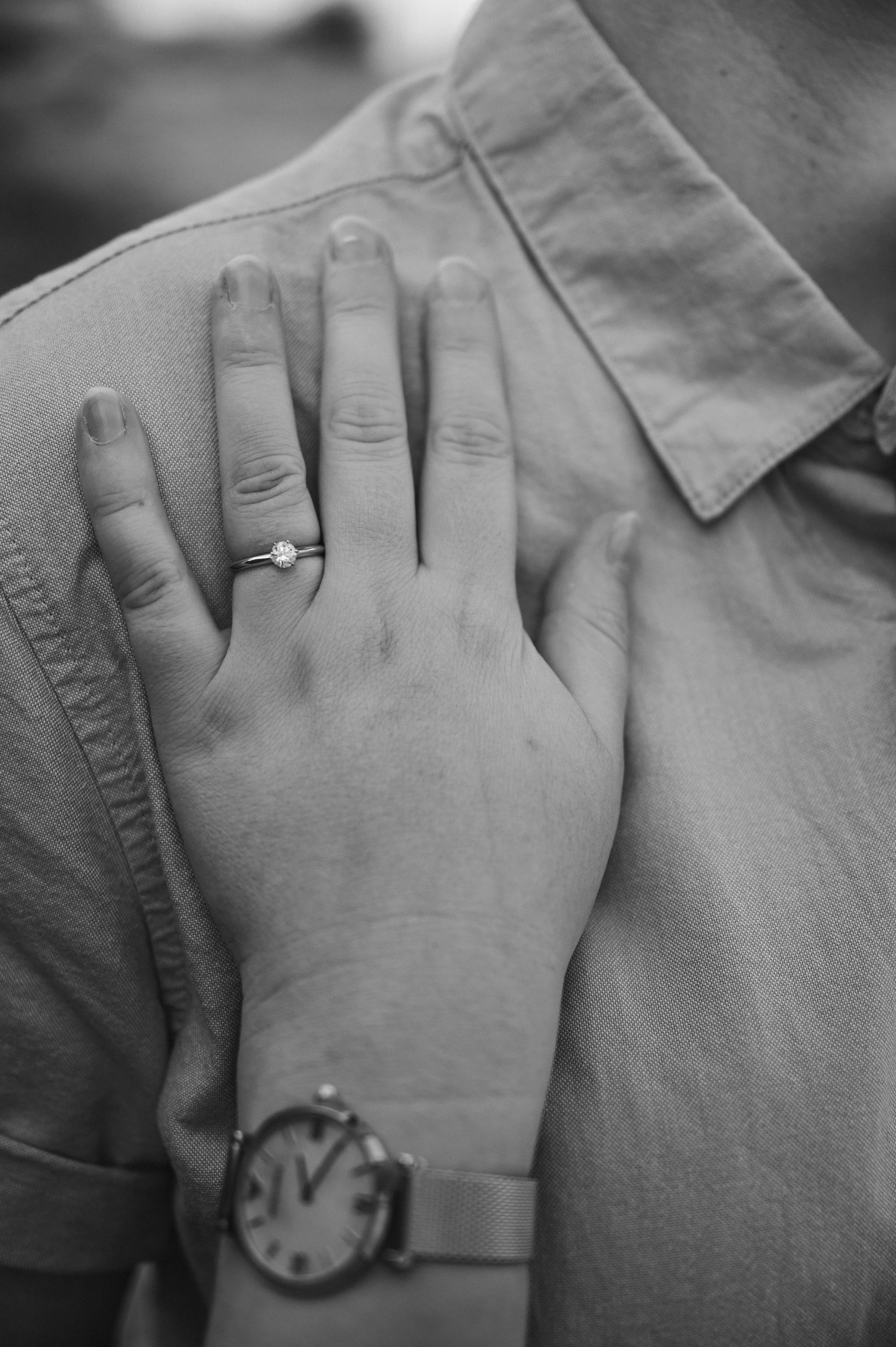 Mow Cop Engagement Shoot - black and white image of hand on someones chest, showing a diamond engagement ring. 