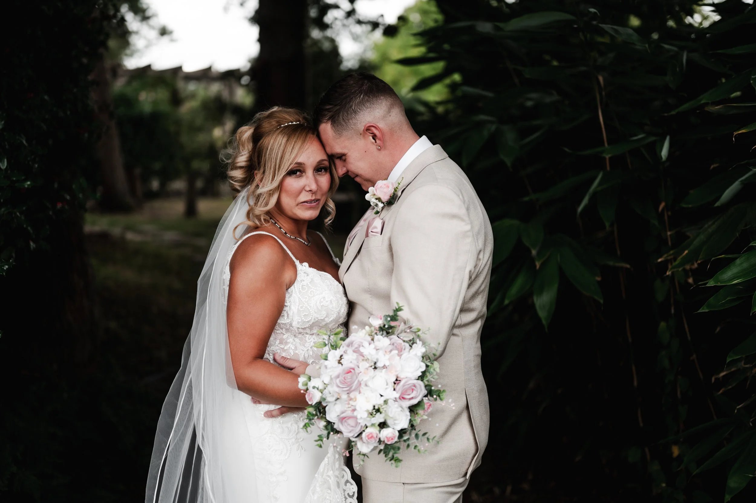 The Love Shack - Groom and bride in wedding attire with bride looking at the camera and groom looking at her.