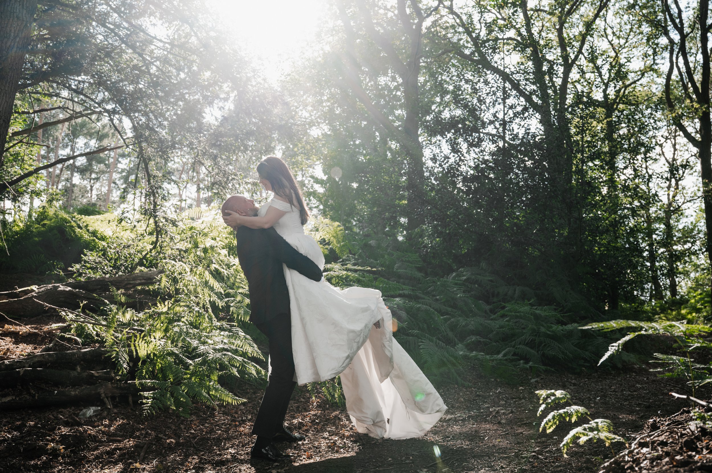 Peckforton Castle - Bride being picked up by  groom in wedding attire in a woodland 