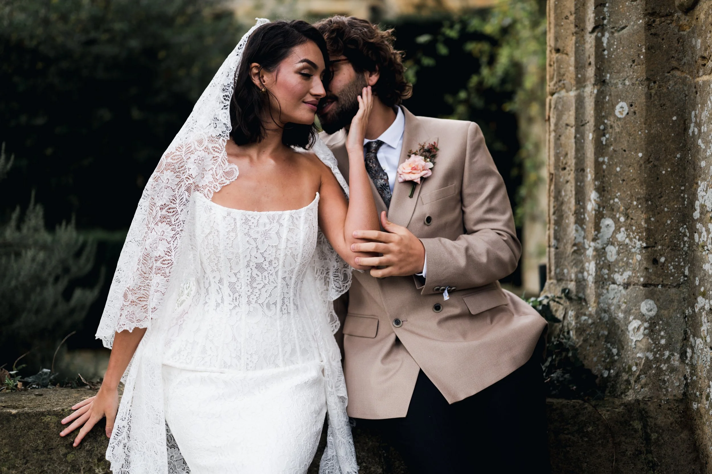 Bride and groom kissing outside Sudeley Castle documentary wedding photography