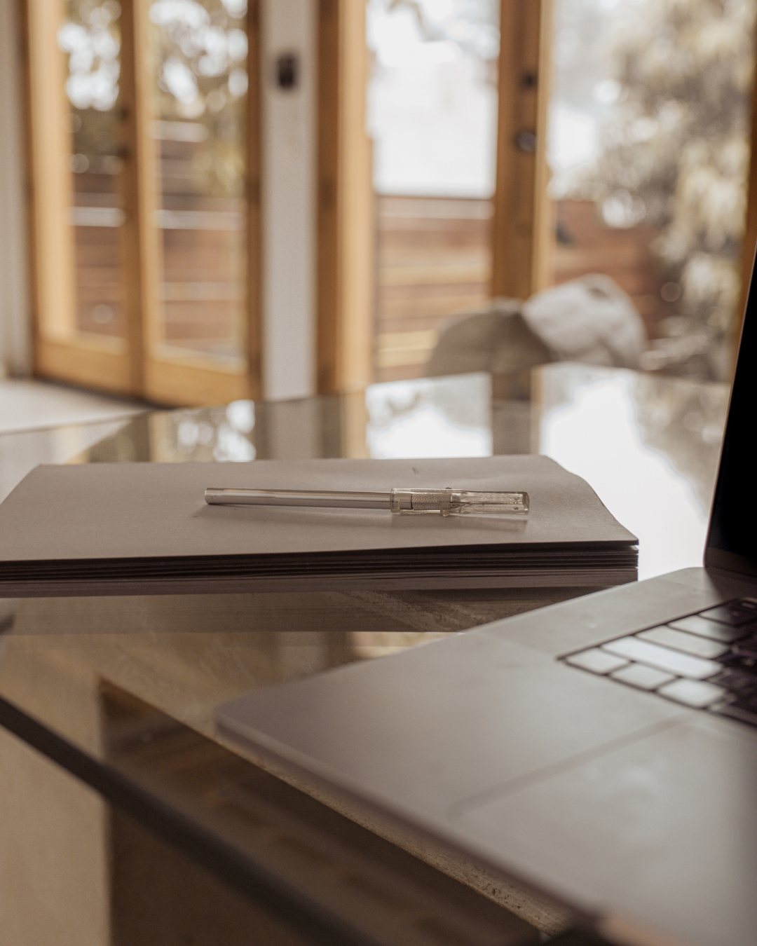 Workspace flat lay with notebook, pen and laptop, representing strategic social media planning.