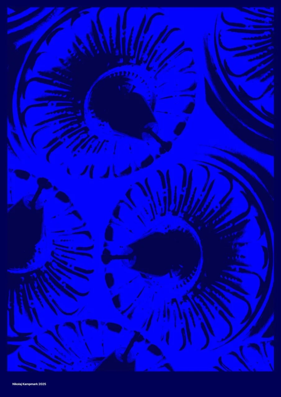 Close-up of a patterned surface featuring large, abstract, eye-like shapes in blue tones with black centers.