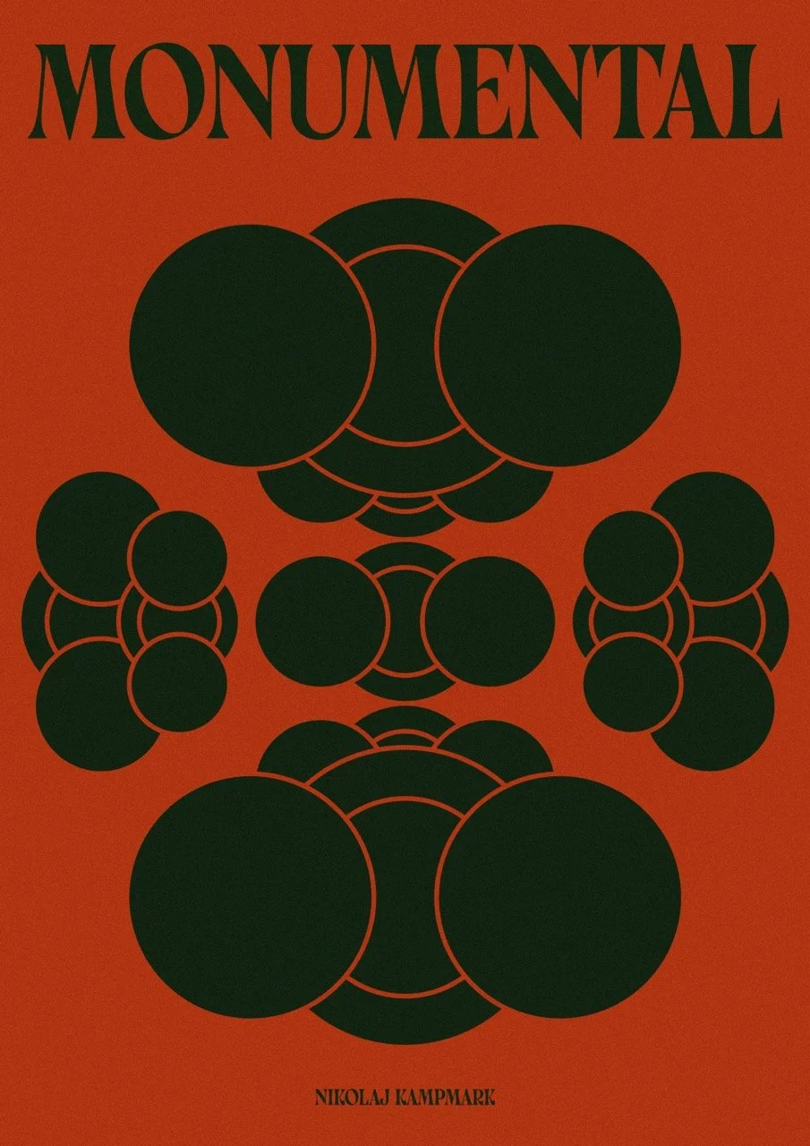 Book cover titled 'Monumental' by Nikolaj Kampmark, featuring a red background with abstract black circle designs outlined in red.