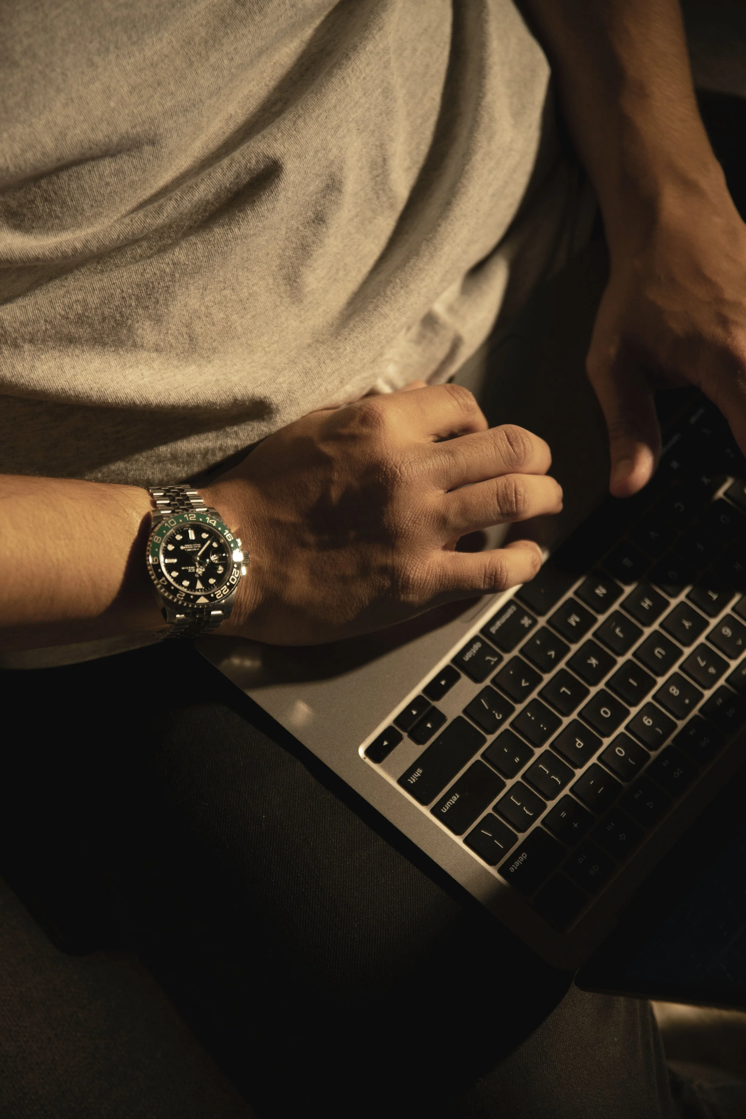 Hand with watch on computer. Photo by Redd Francisco on Unsplash