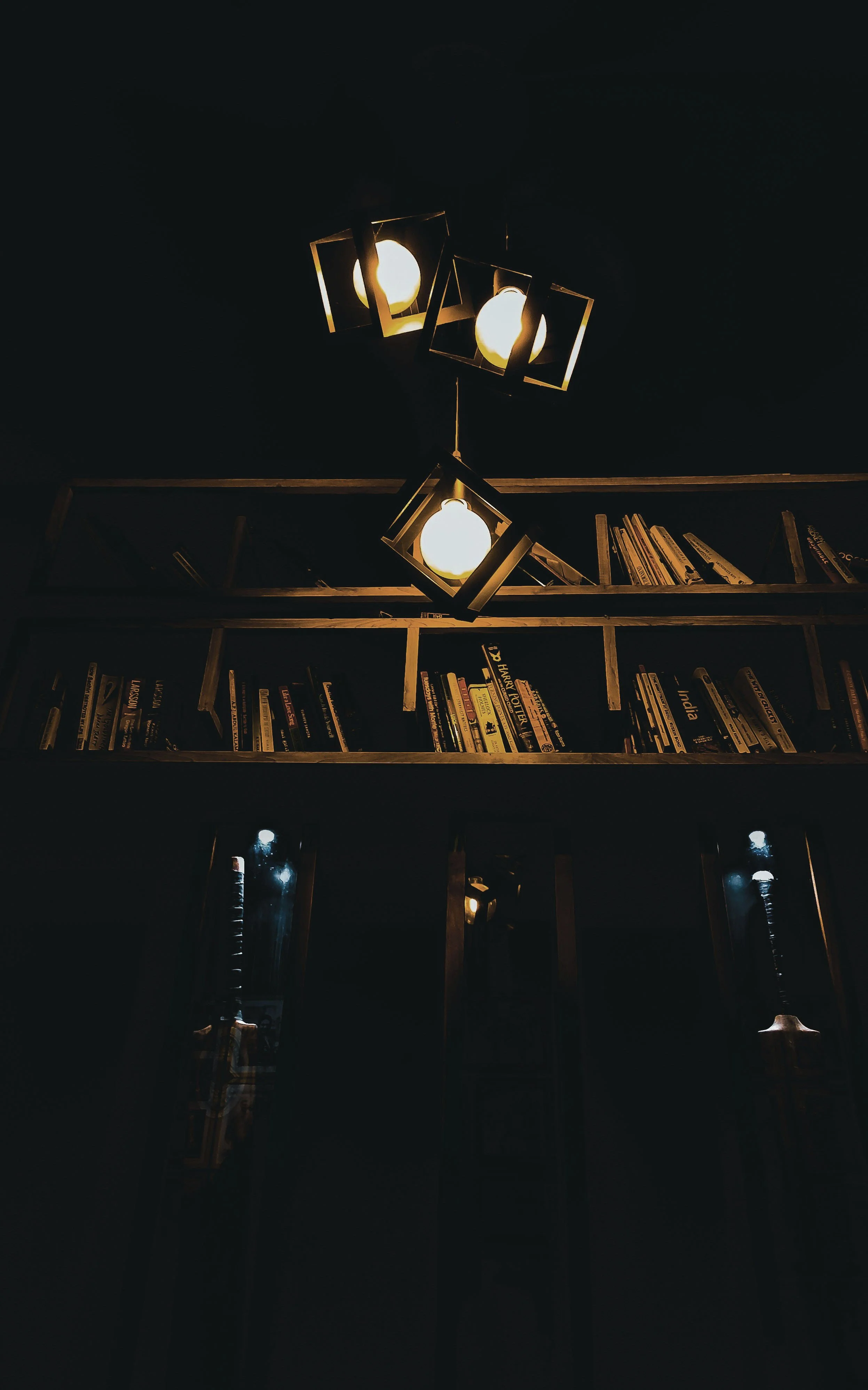 Dimly lit bookshelf. Photo by Nikhil Thomas on Unsplash