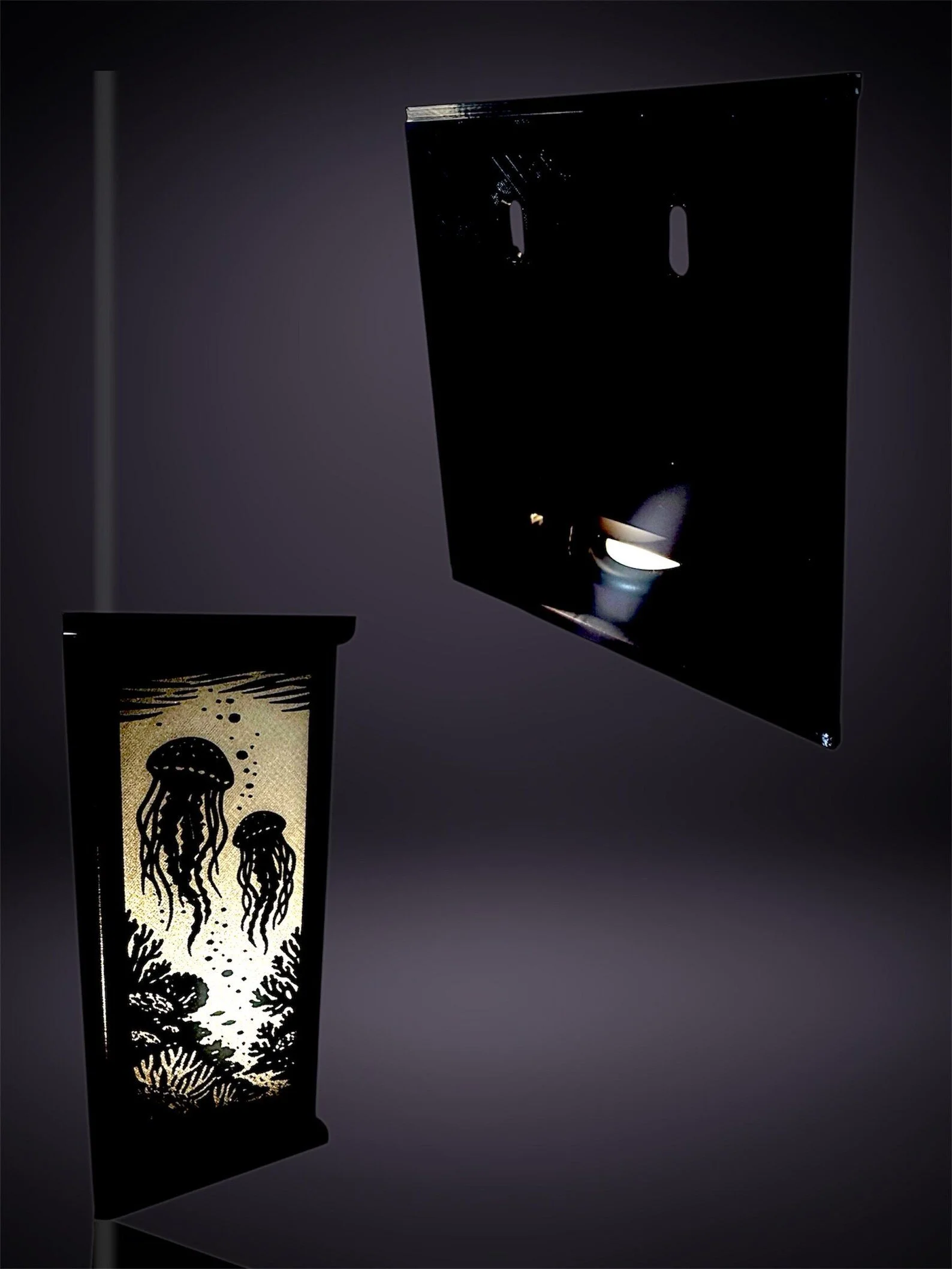 Lit rectangular lantern featuring jellyfish designs, with a metallic cover or panel nearby.