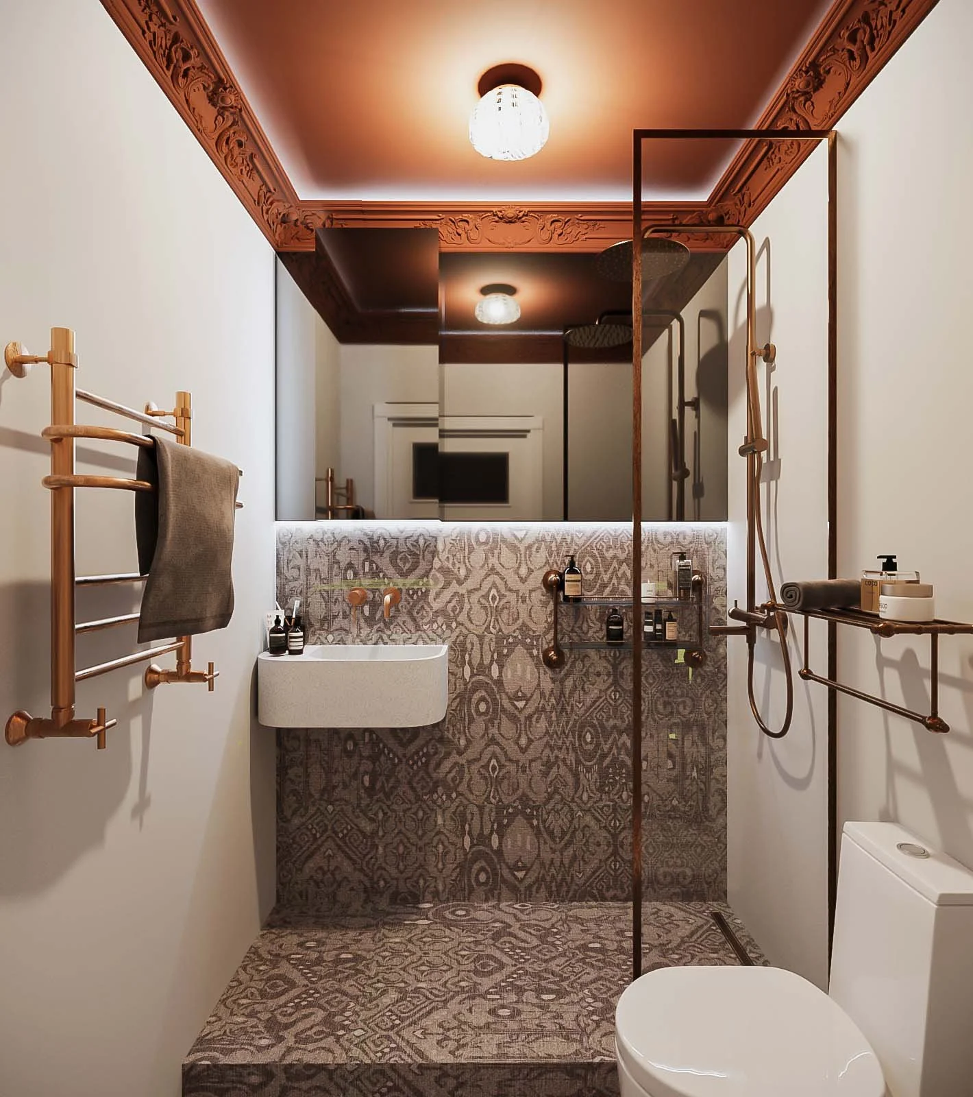 Modern bathroom with patterned tiles on the shower wall and floor, a white toilet, a wall-mounted sink with toiletries, and gold fixtures, illuminated by ceiling lights and a large mirror.
