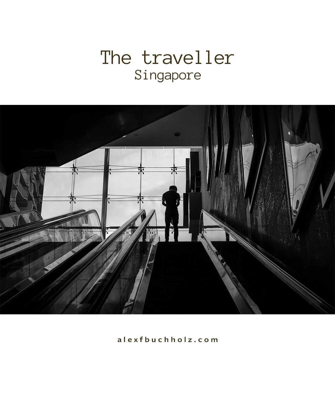 Silhouette of a person standing at the top of an escalator in a modern indoor space with large windows.