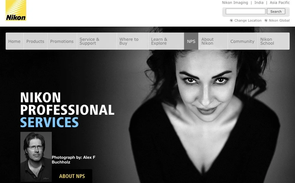 Screenshot of Nikon Professional Services webpage with a black-and-white photo of a woman smiling and a small photo of a man, with navigation menu at the top.