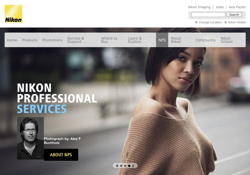 Screenshot of Nikon's professional services webpage featuring a young woman with short dark hair wearing a beige sweater and looking at the camera, with navigation menu options at the top.