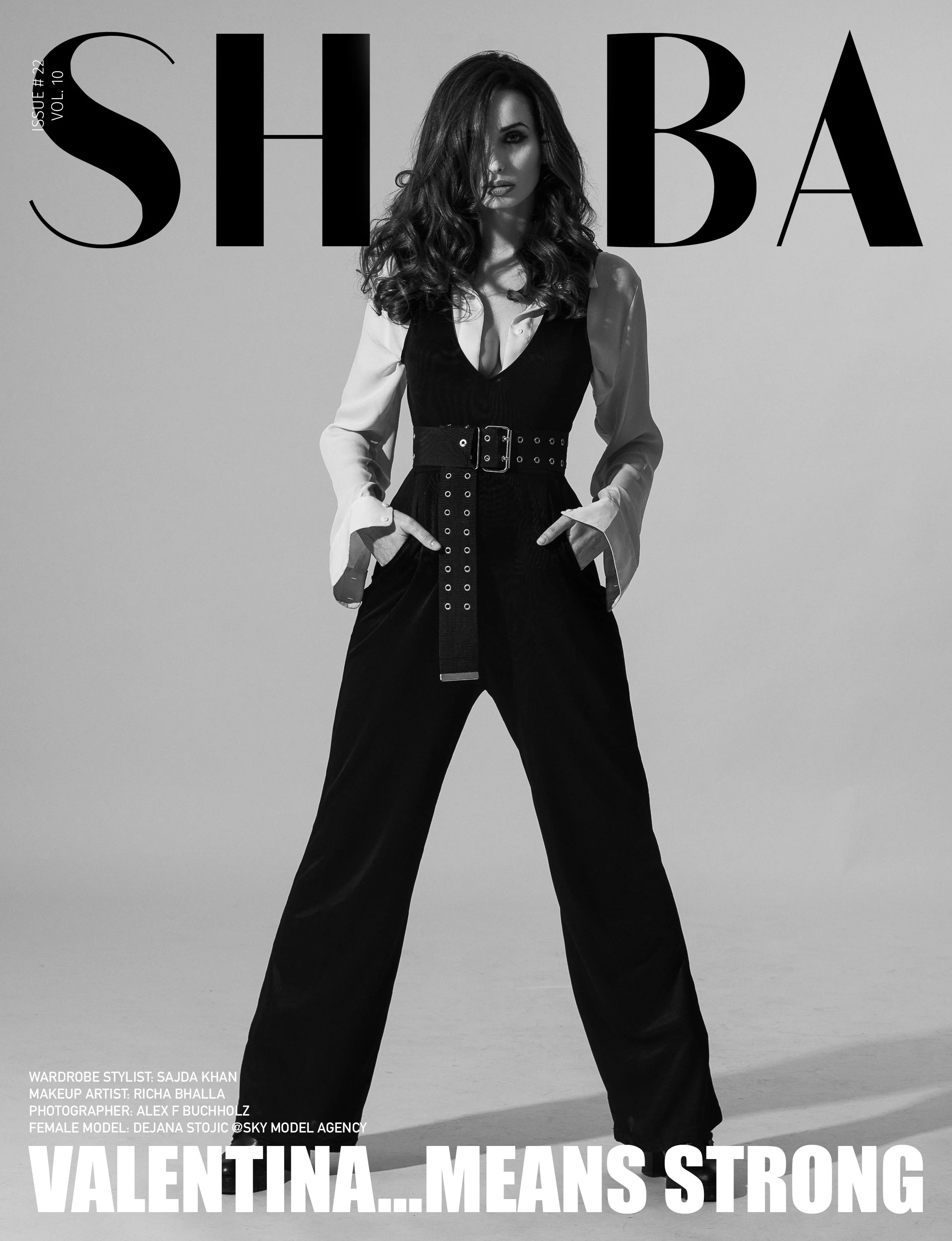 Black and white fashion magazine cover featuring a woman with curly hair wearing a black jumpsuit, white shirt, and belt. The magazine title is 'SHOBA', with the tagline 'Valentina... Means Strong' at the bottom.