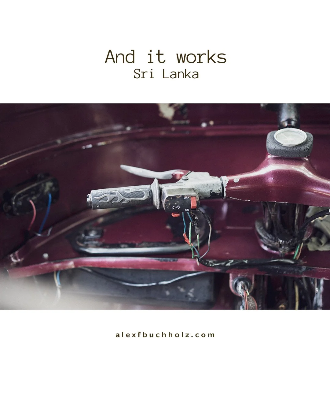 Close-up of an old, dusty motorcycle handlebar with wires hanging down, set inside a maroon motorcycle body. Text on top reads 'And it works, Sri Lanka'.
