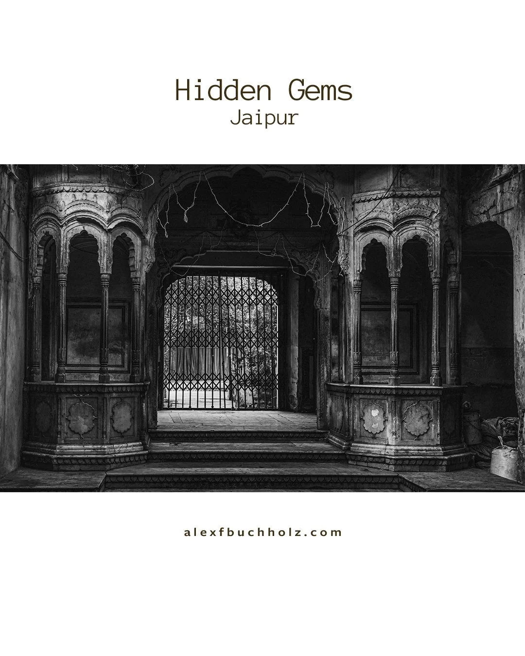 Black and white photo of an old, ornate temple or palace entrance with intricate carvings and a metal gate.