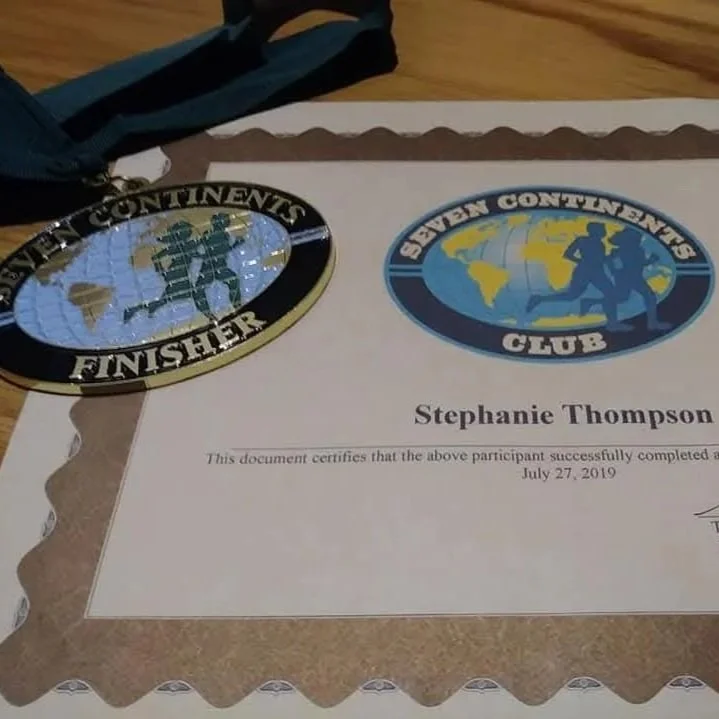 Certificate and medal showing Stephanie Thompson finished marathons on all seven continents