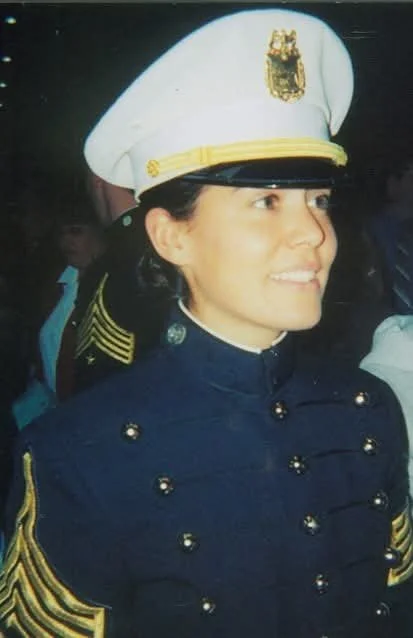 Young woman wearing U.S. Navy dress uniform