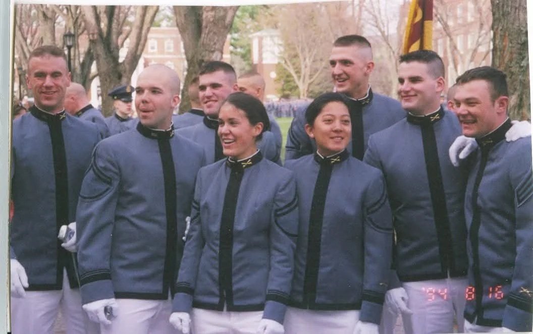 Group of eight people wearing matching uniforms