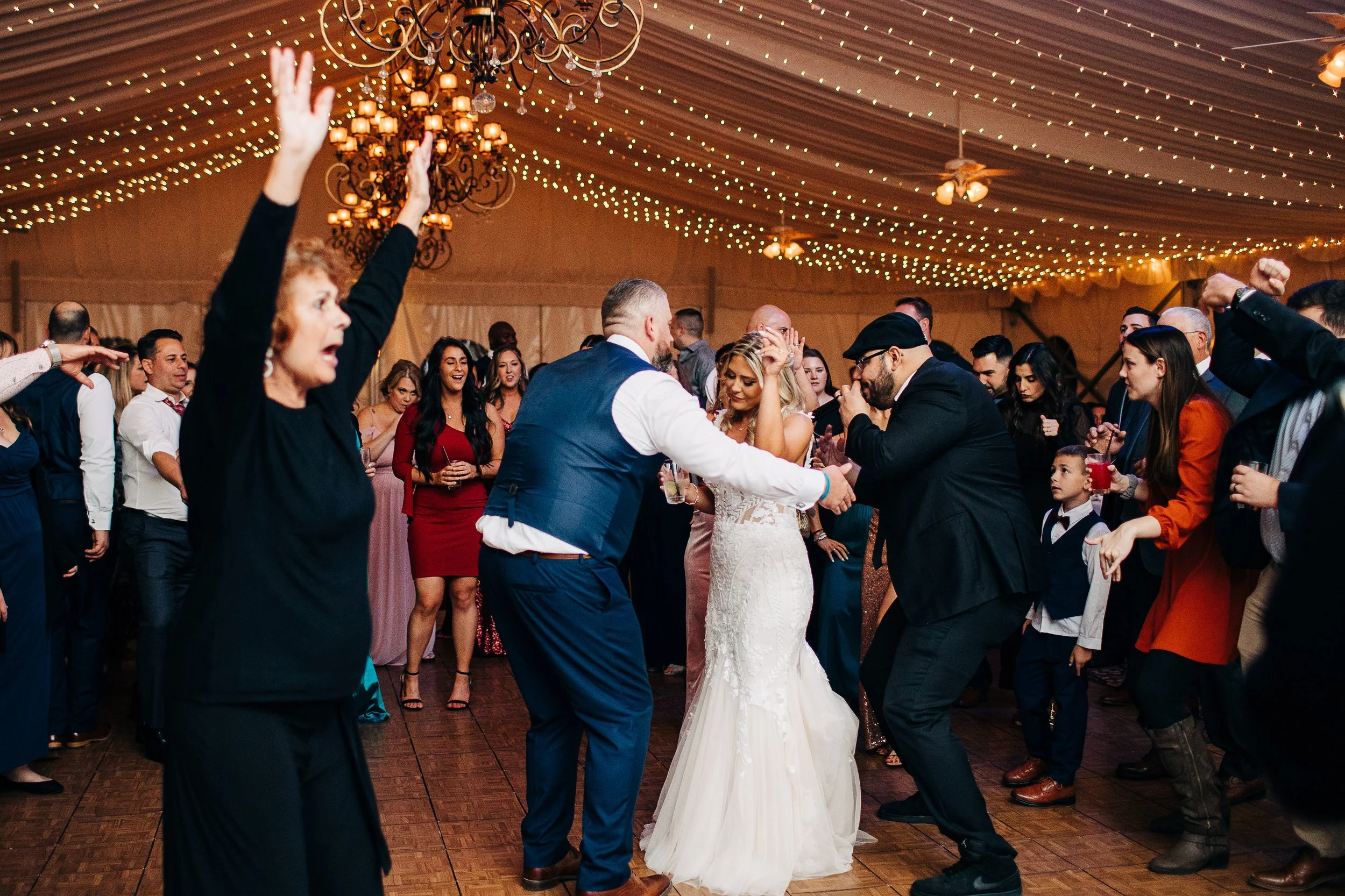Wedding guests dancing under twinkle lights