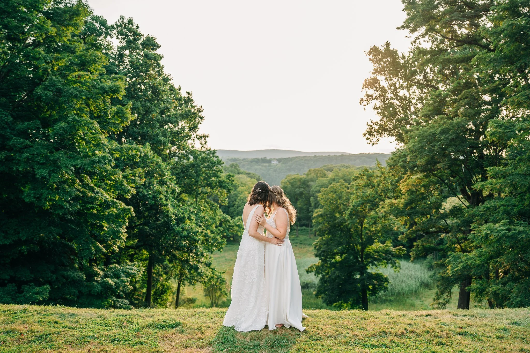 Brides overlooking forest and valley in the Catskills