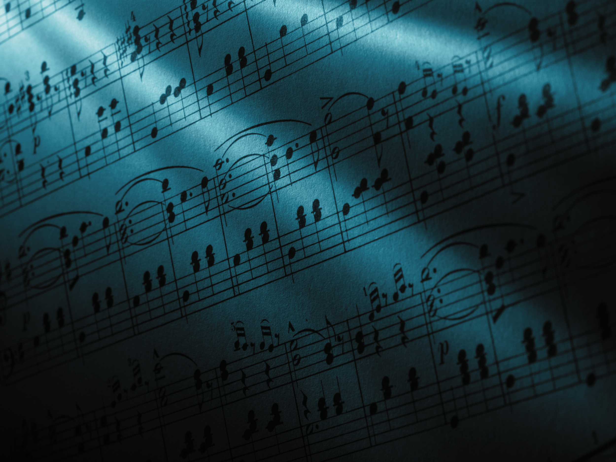 Close-up of sheet music with musical notes and symbols on a blue-tinted background.