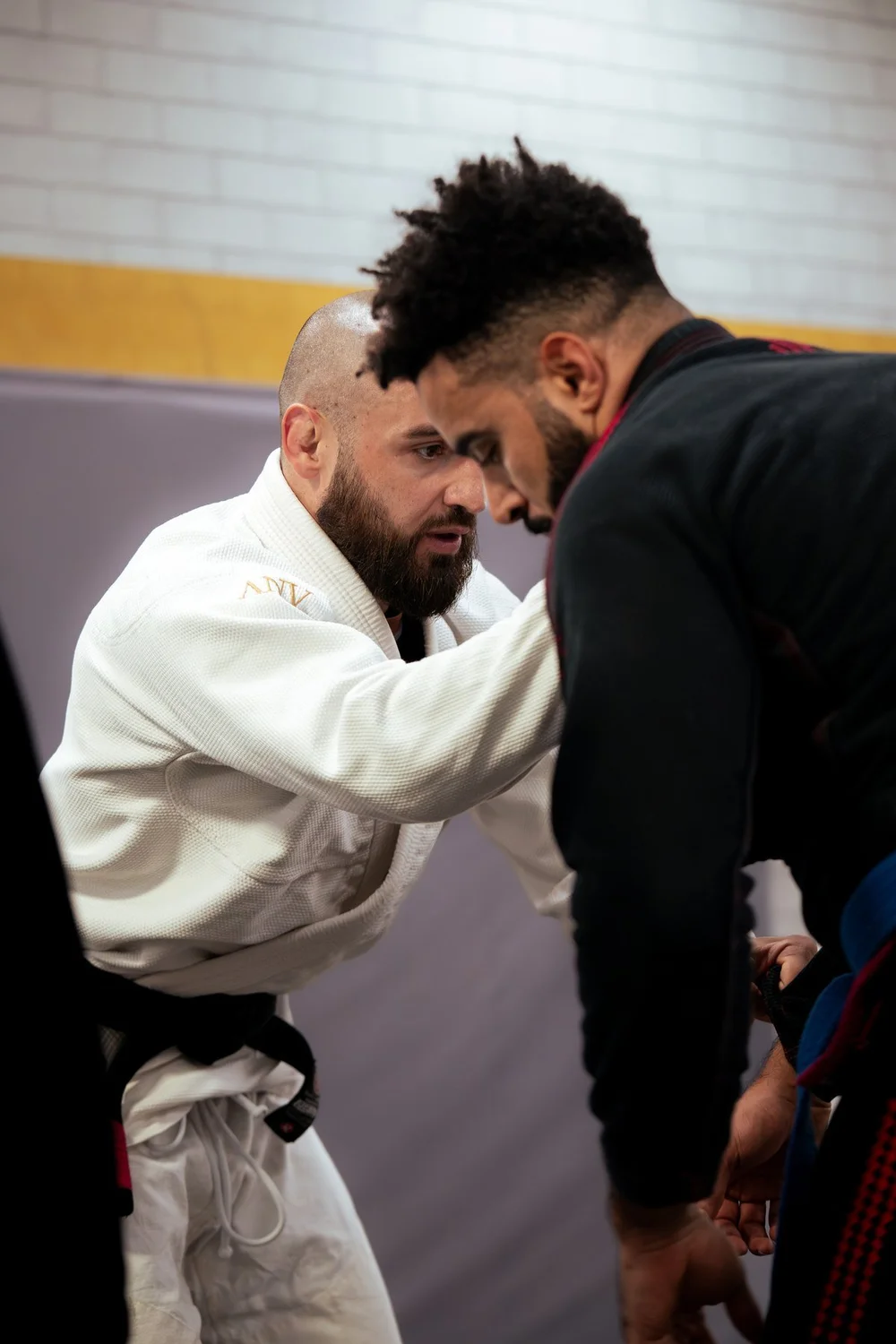 Two training partners practising Brazilian Jiu-Jitsu grips at Fight Sports Muscat