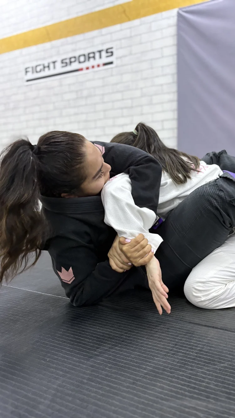 Training partners practising Gi techniques in a women-only BJJ session