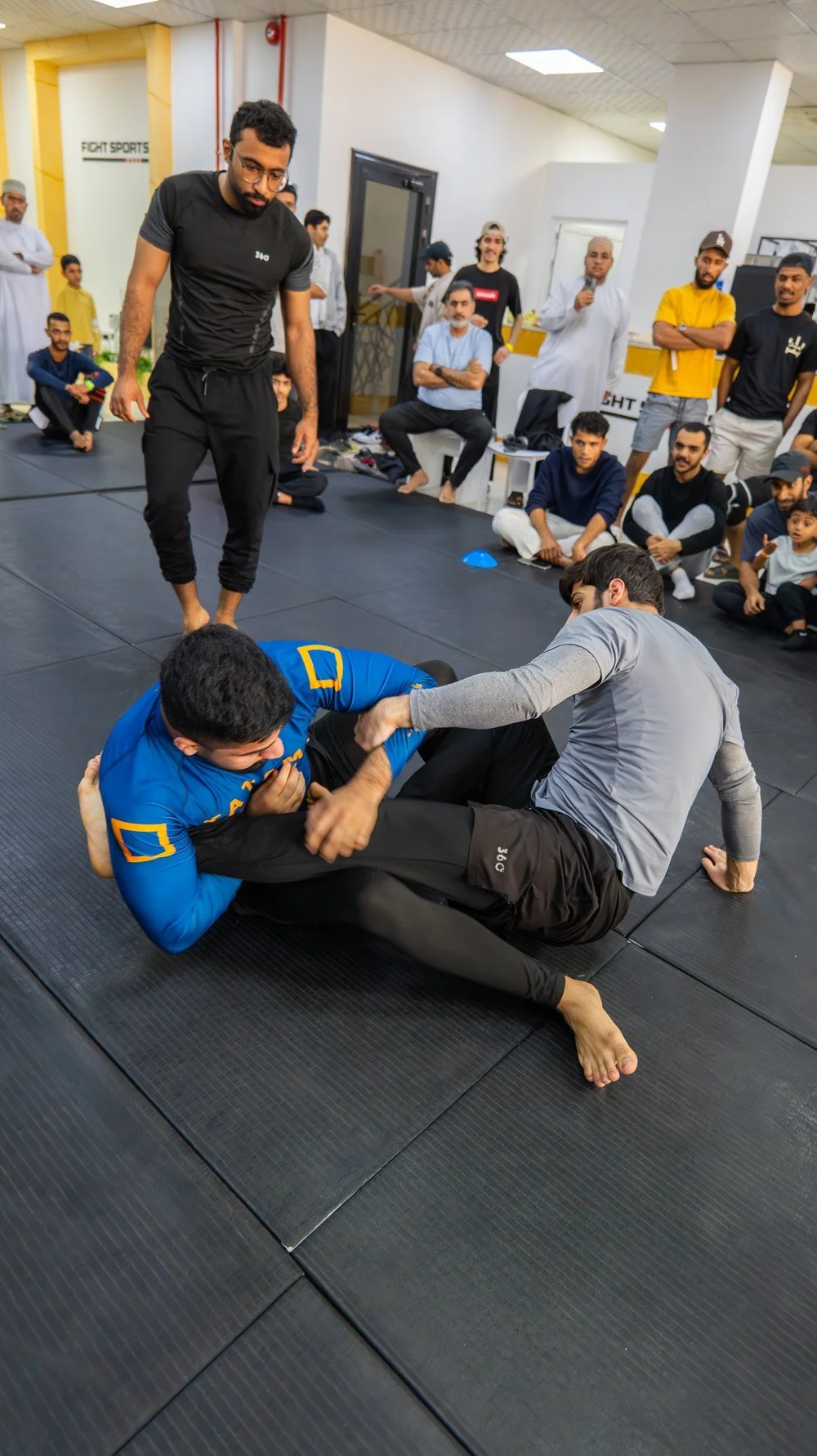 Training partners practising No-Gi grappling at Fight Sports Muscat