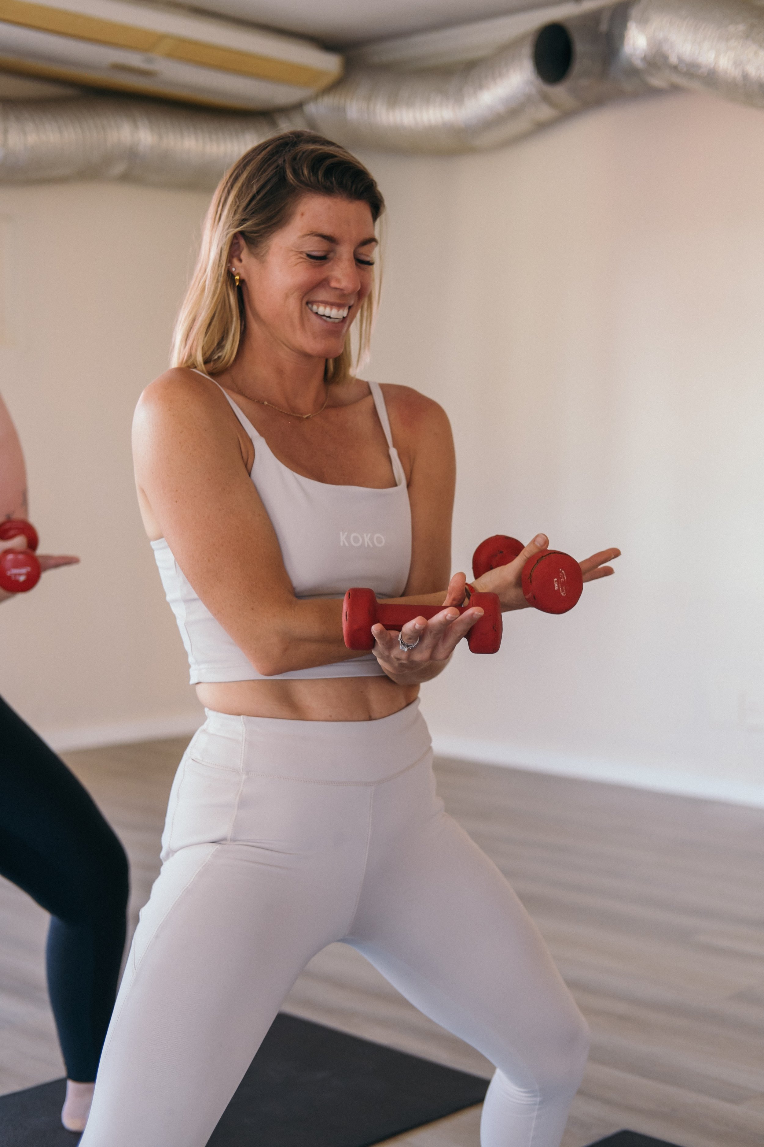 woman doing yoga sculpt with weights in class for everyone