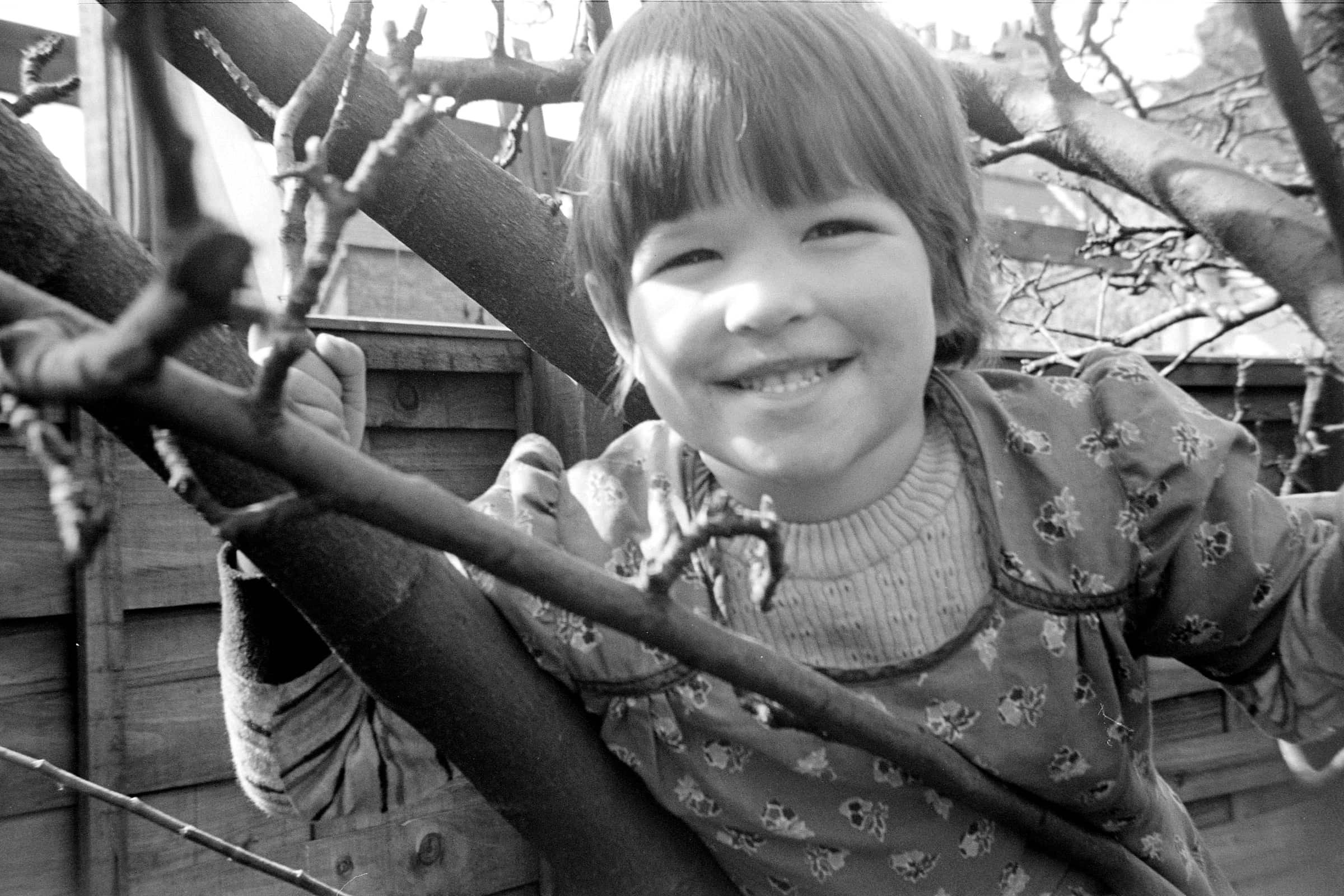 Mari Williams climbing a tree aged 6