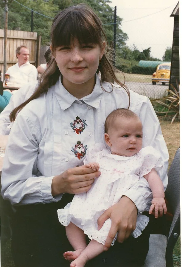 Mari Williams holding a baby aged 17
