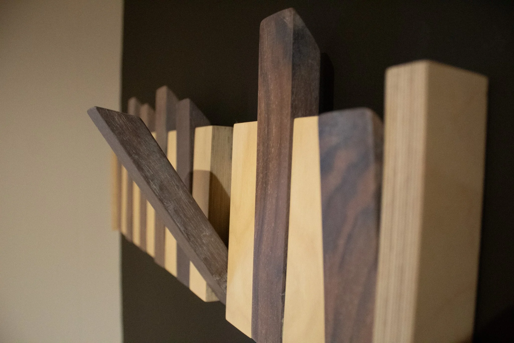 Close-up of stacked wooden slats in various shades of brown and beige.