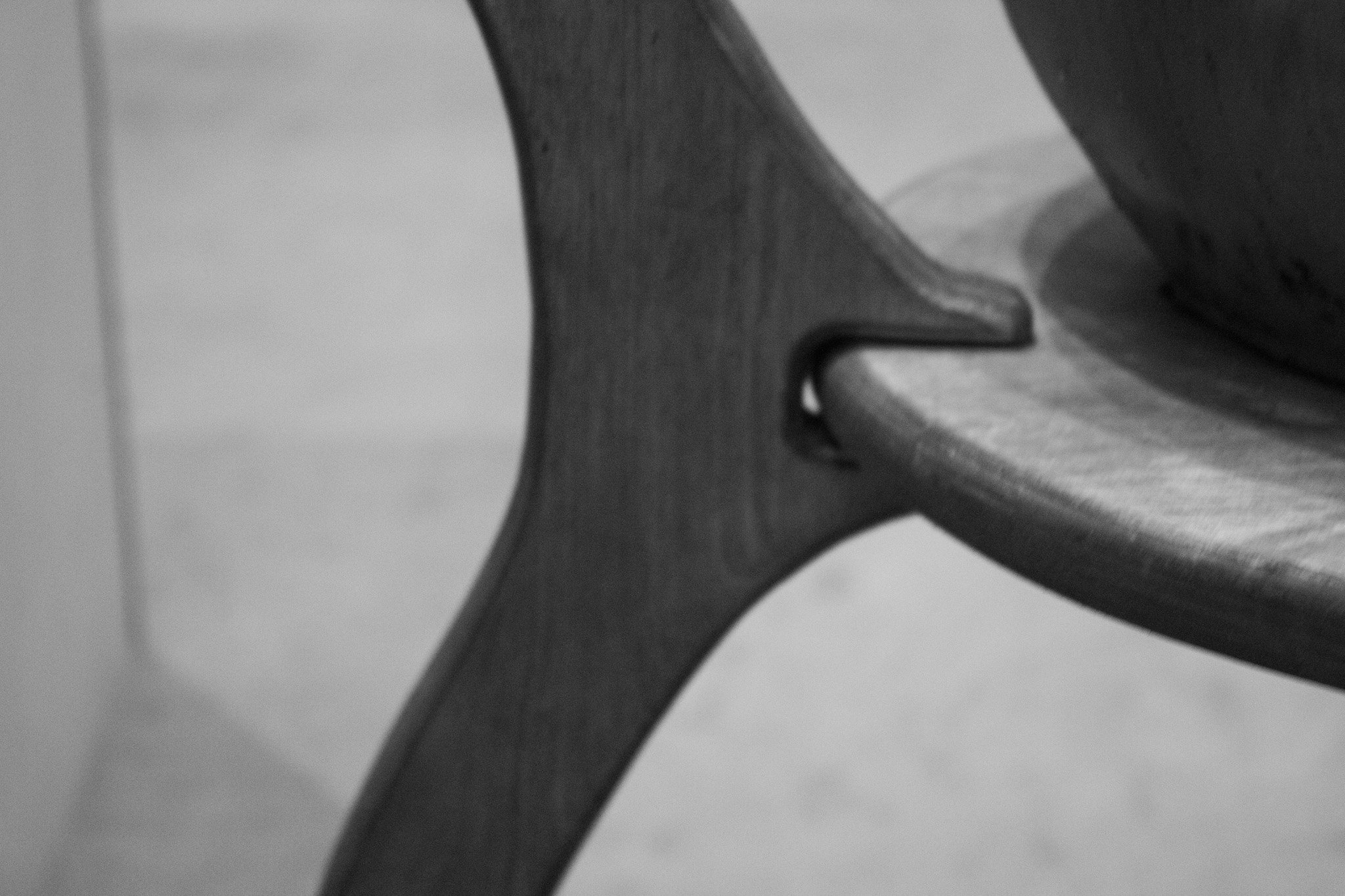 Close-up of a wooden plant stand in black and white.