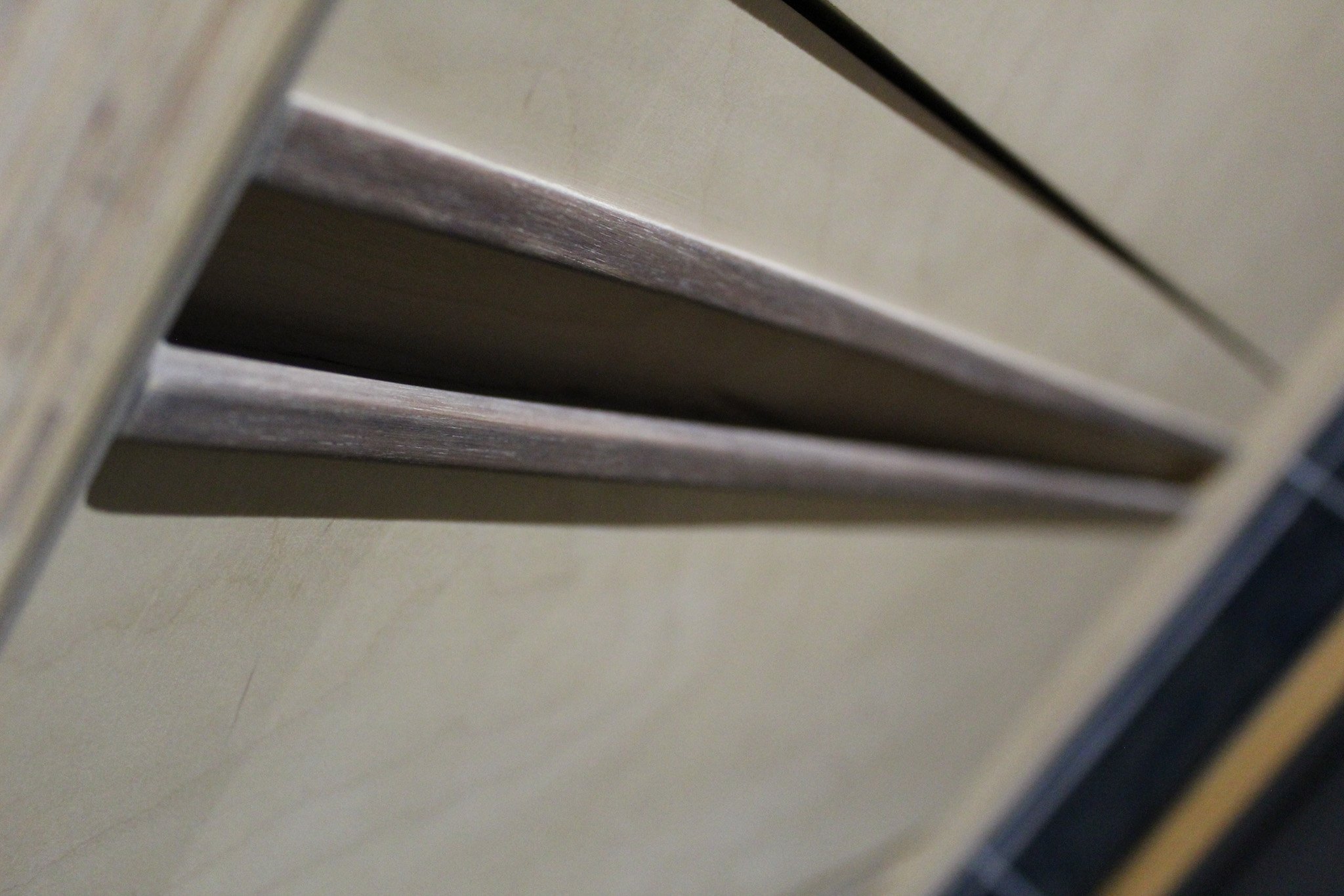 Close-up of a vent cover on a wall or floor.