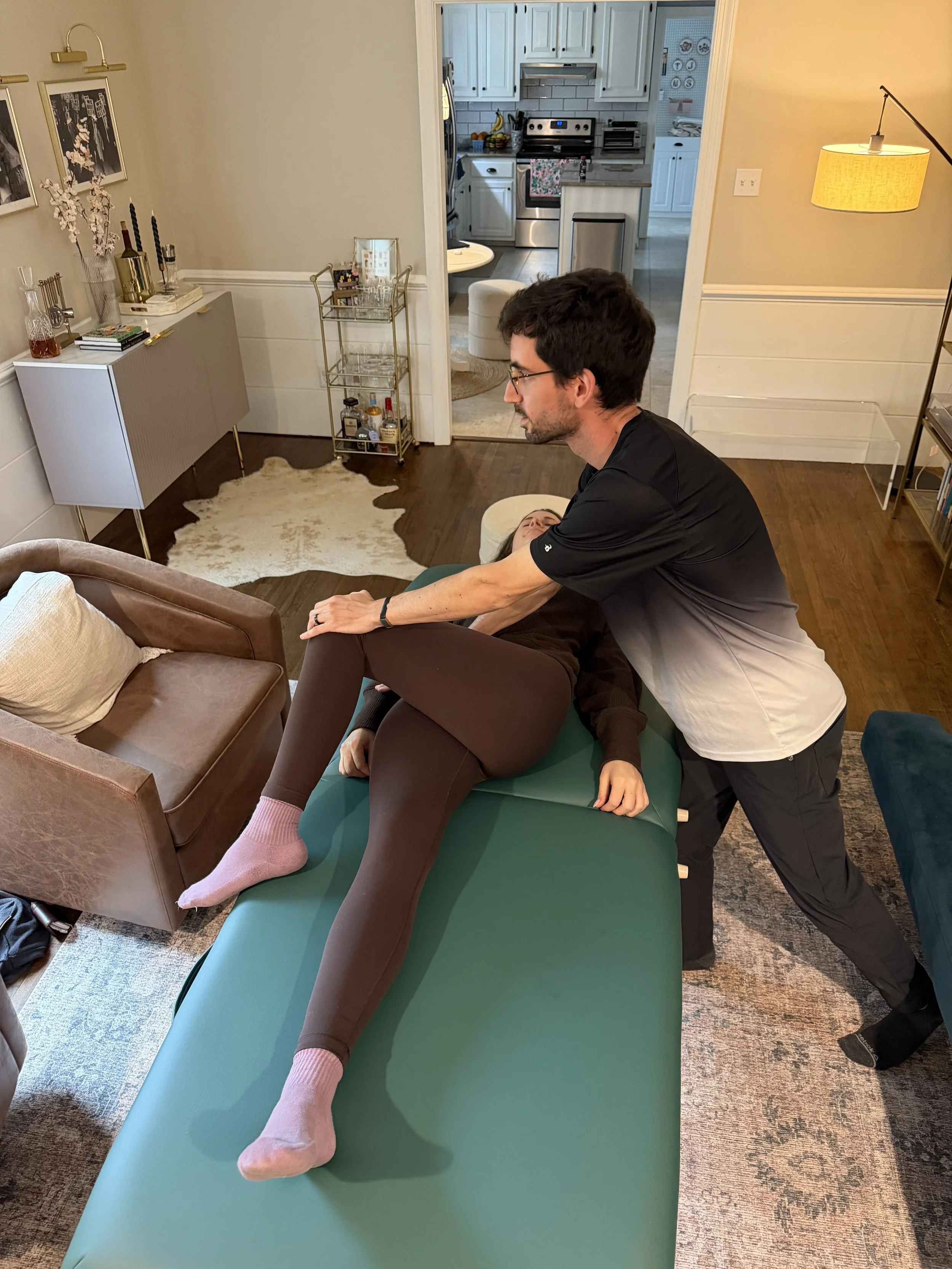 Hall Movement Coach performing assisted stretching on a client at home - mobile stretching service Richmond VA