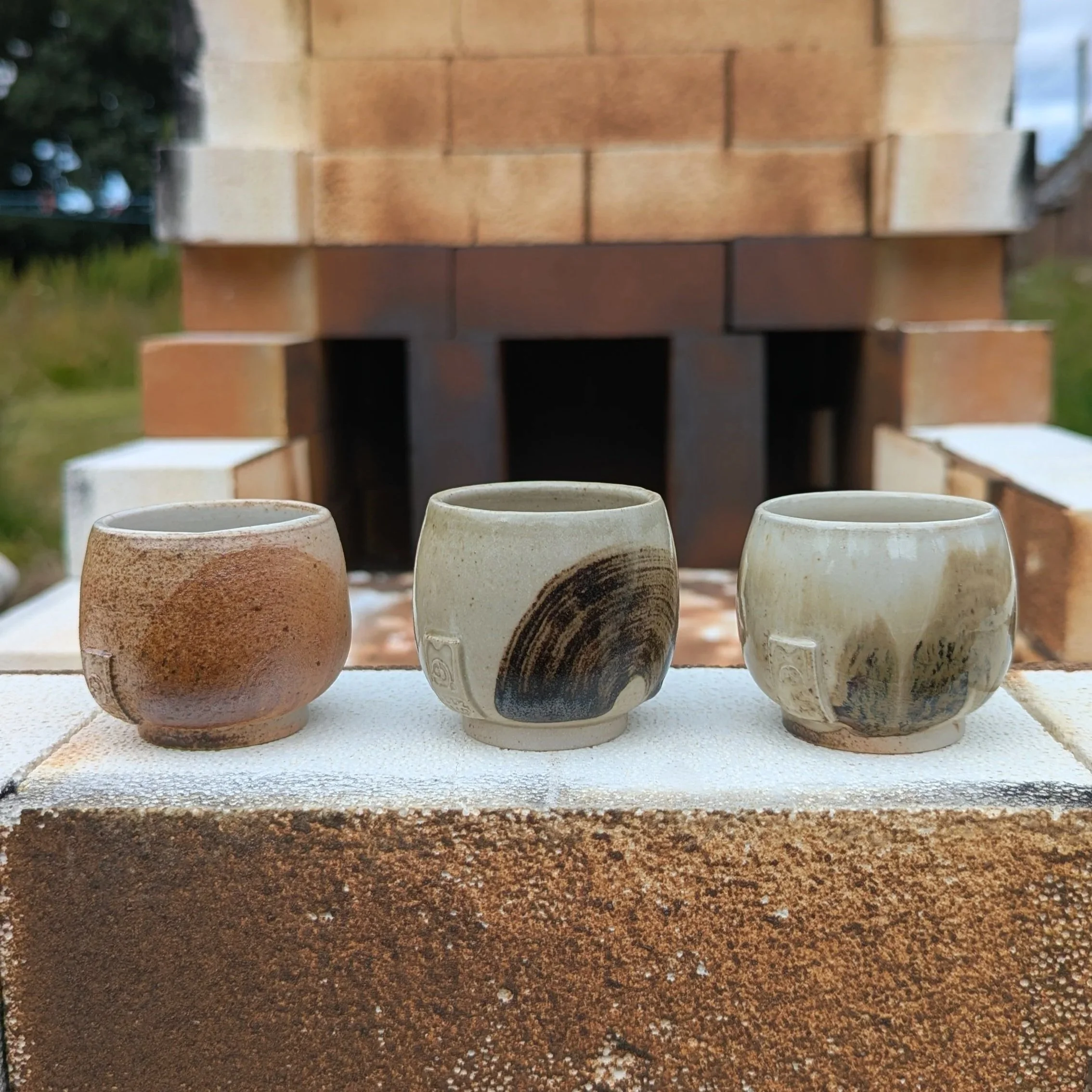 Fast fired stoneware cups with foraged clay slip, July 2026