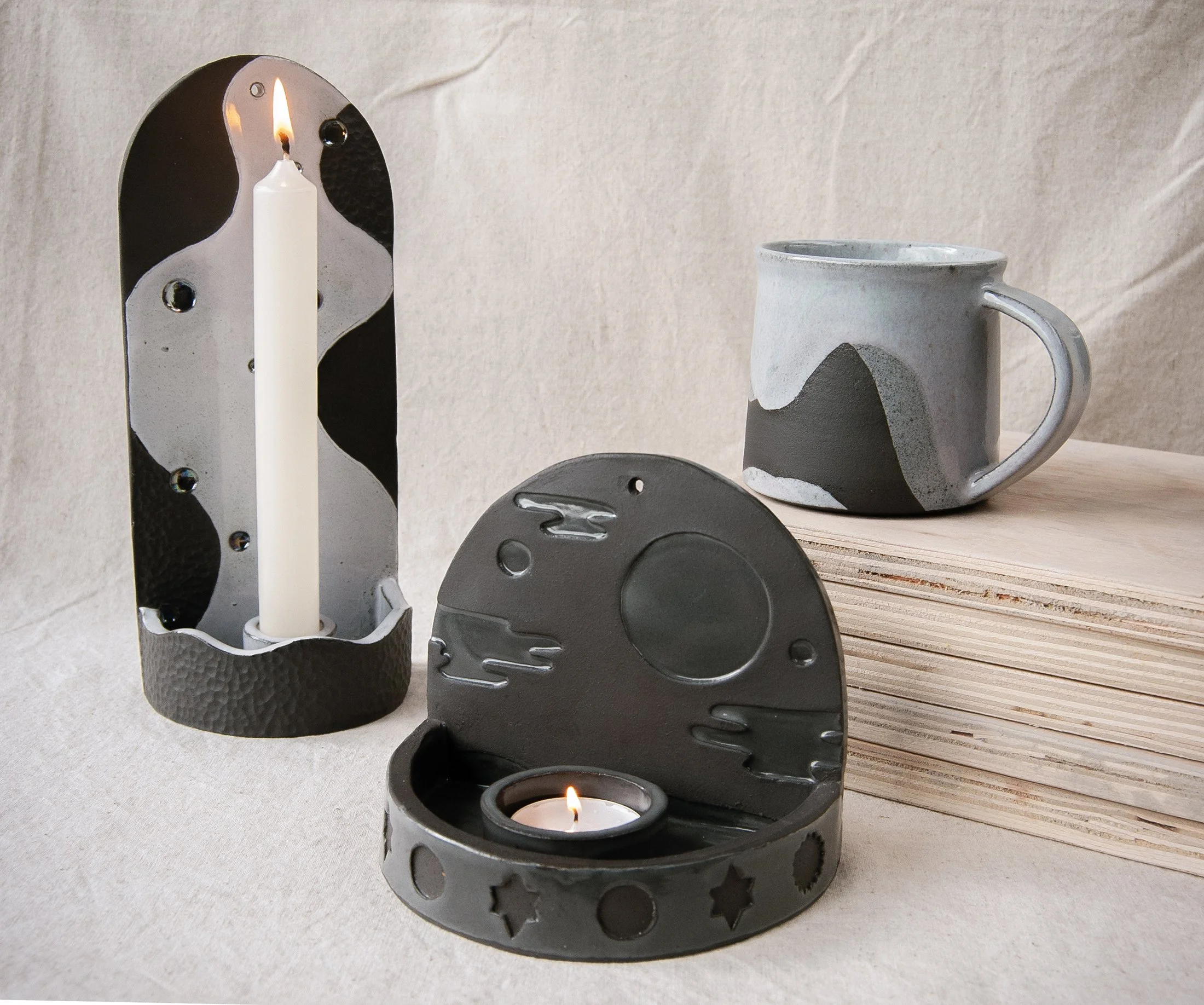 Black stoneware candle sconces and mug