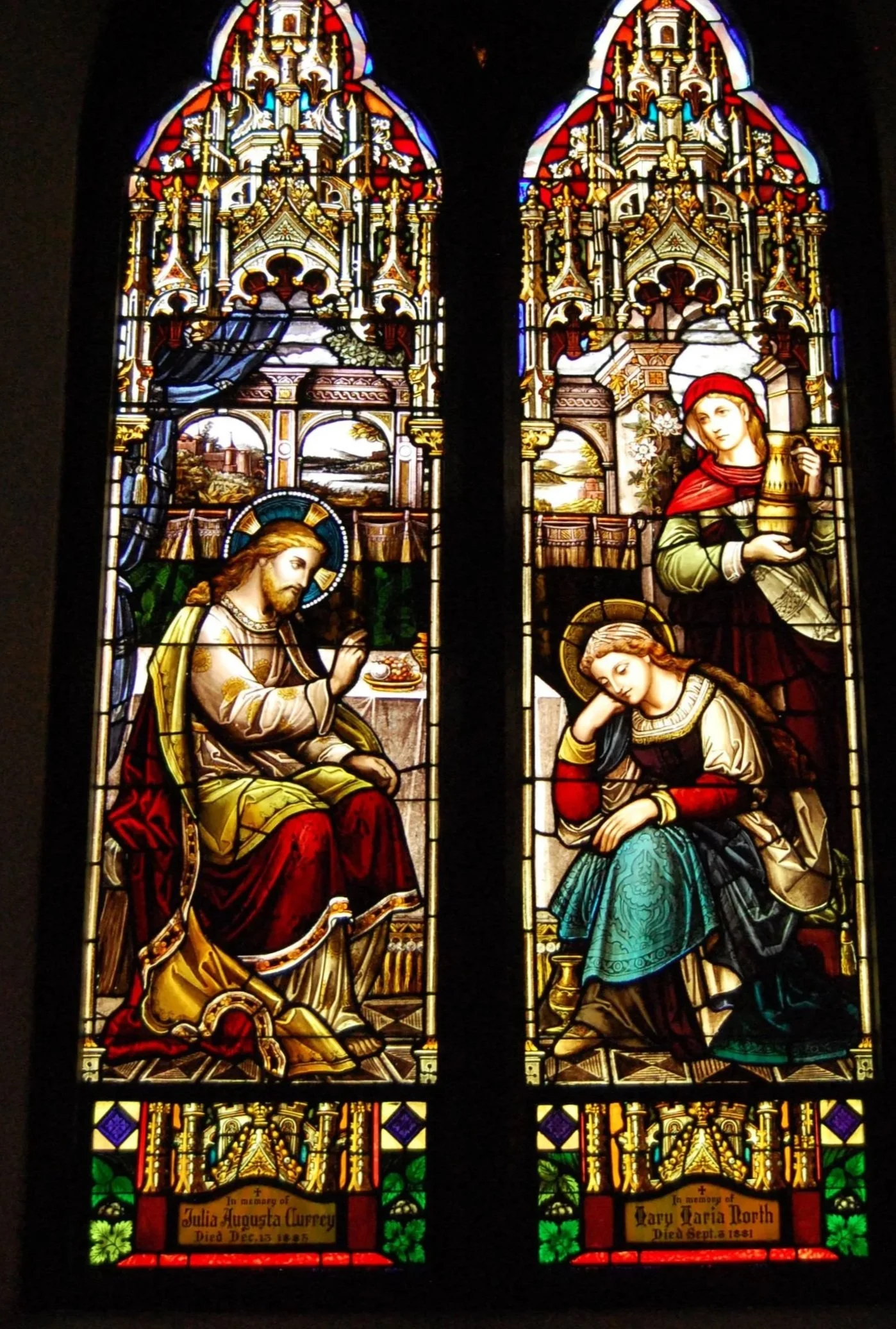 Colorful stained glass window depicting religious scenes