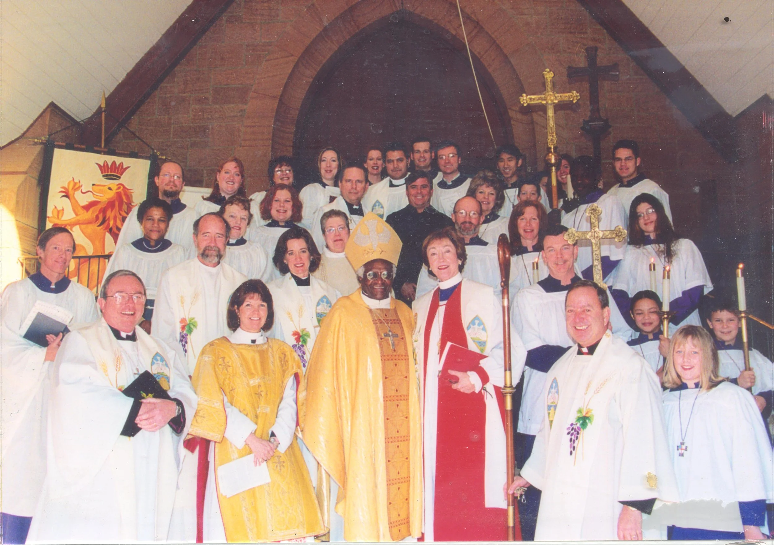 Clergy and children gathered inside the narthex of St Mark's Cathedral for visit by Archbishop Desmond Tutu in 2002.