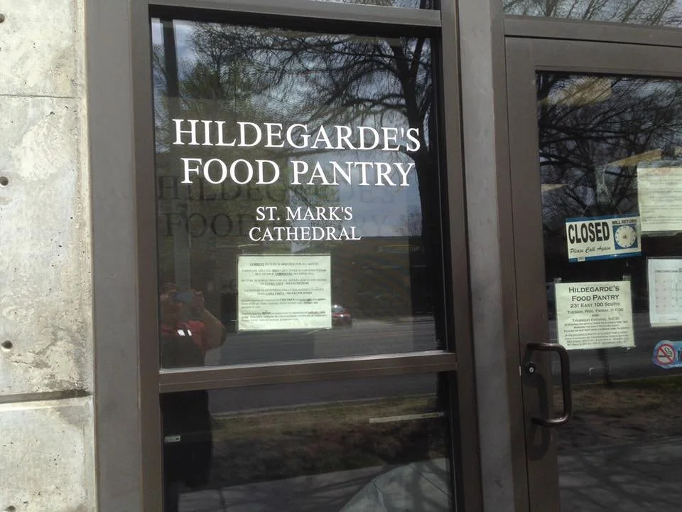 Glass door with signs for Hildegrade's Food Pantry at St. Mark's Cathedral