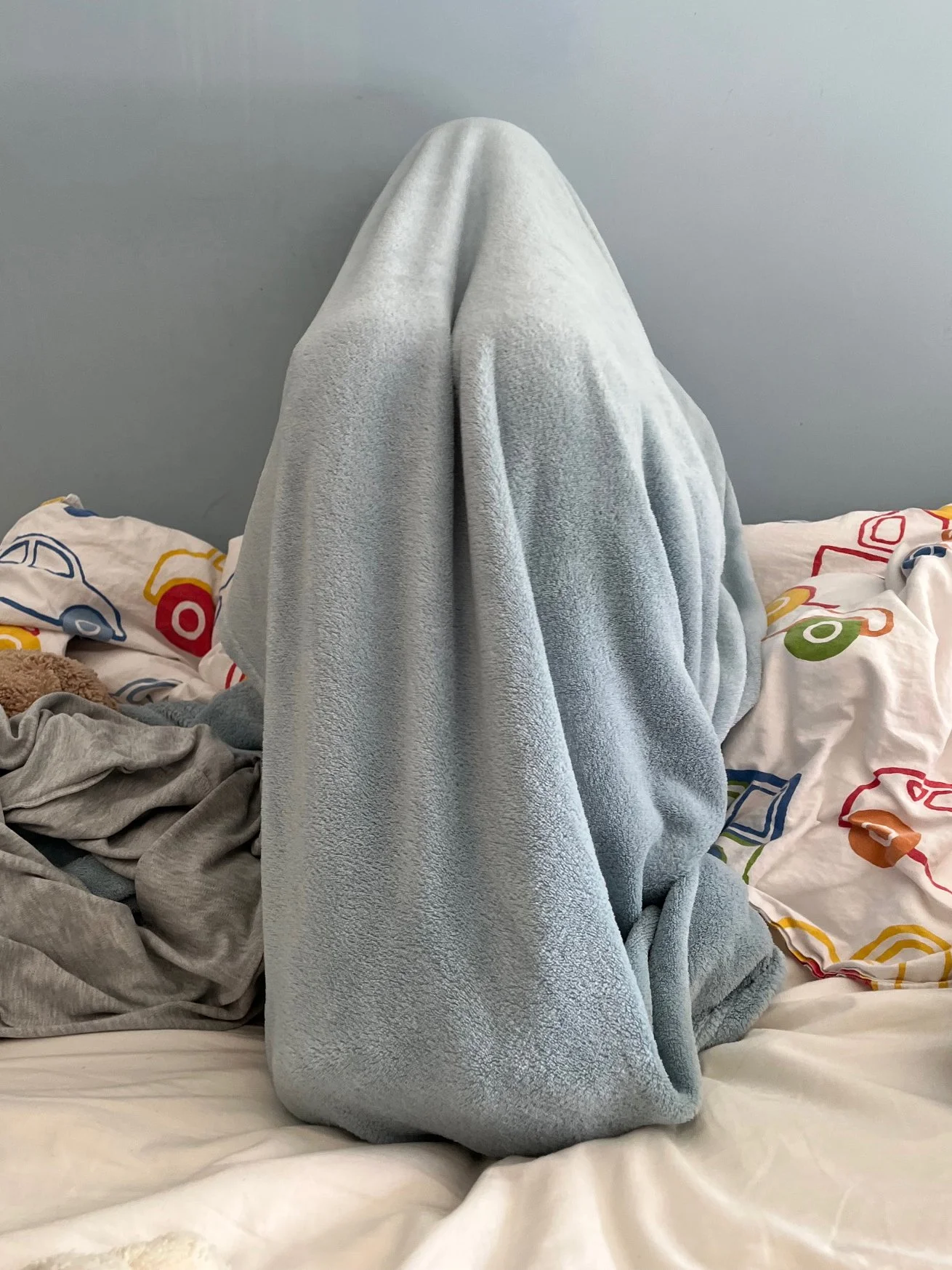 John, 10: Photograph taken by John's parent, who says: Just sending a photo which is my son’s place of retreat, covered up in his bed. It’s heartbreaking. Not exactly him de-stressing here, but retreating and trying to block out the difficulties. He 