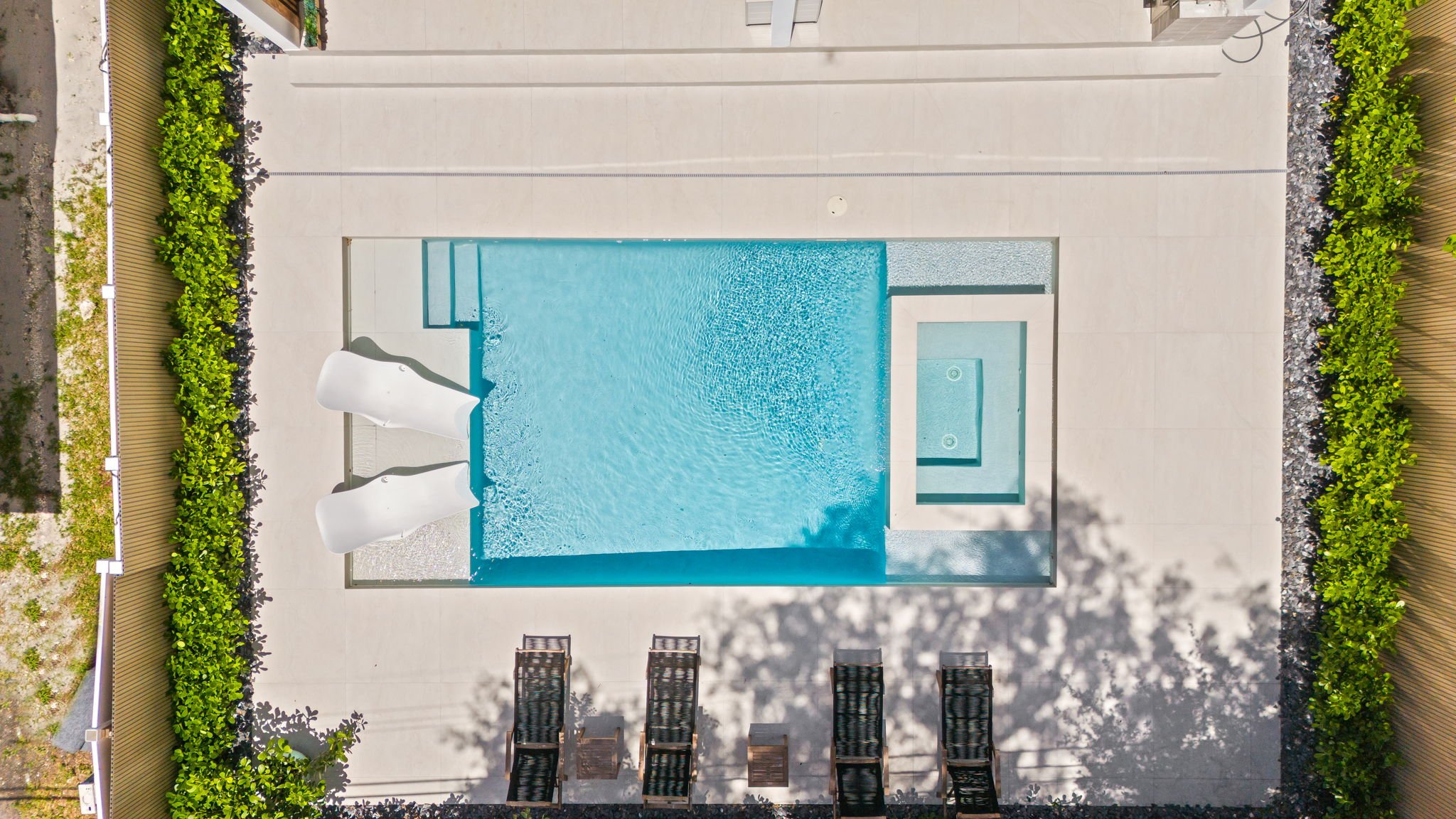 Aerial view of private pool with waterslide and lounge deck — Sun Haven Collection luxury vacation rental.