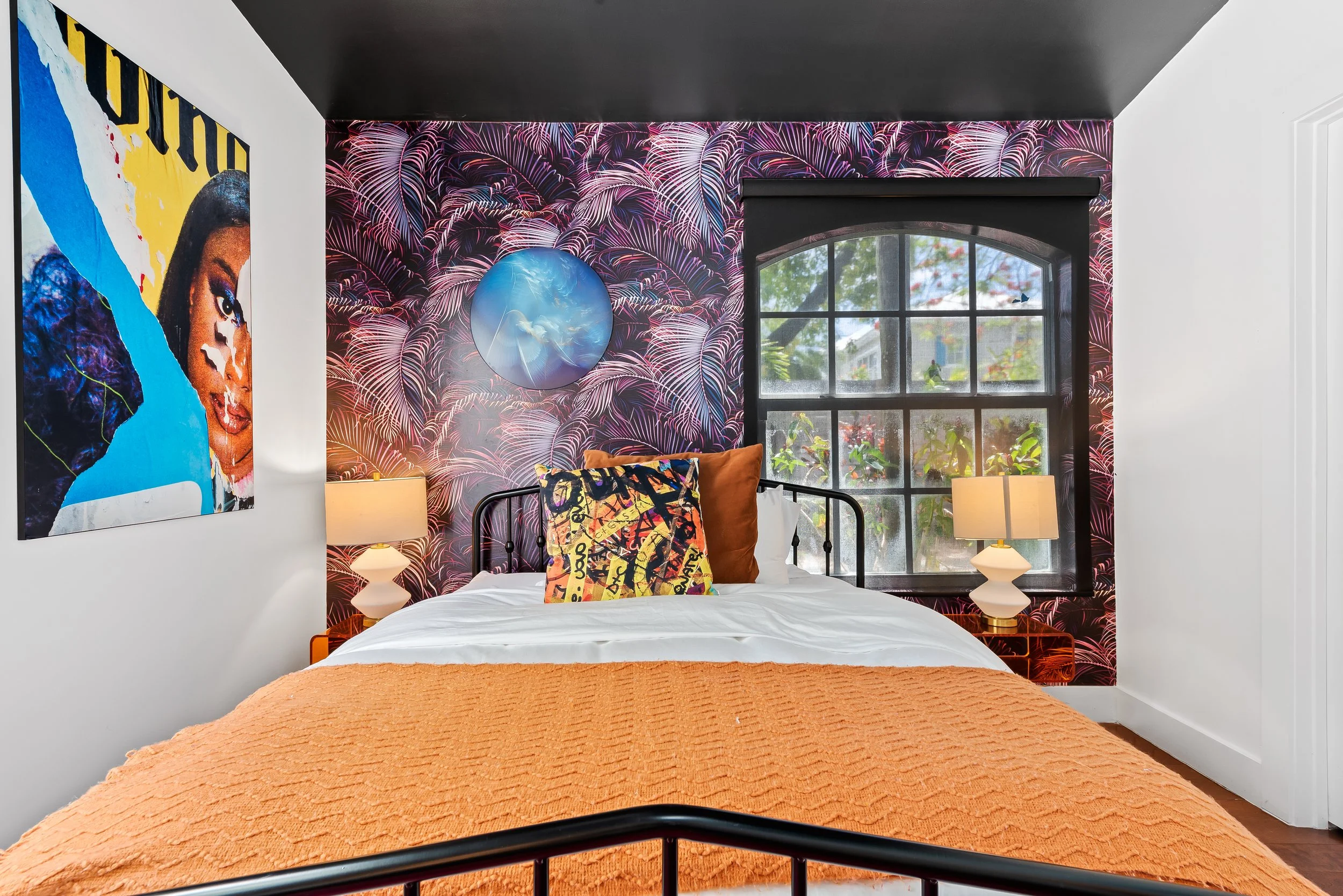 Tropical-themed bedroom with vibrant leaf wallpaper and garden views — luxury vacation home, Sun Haven Collection.