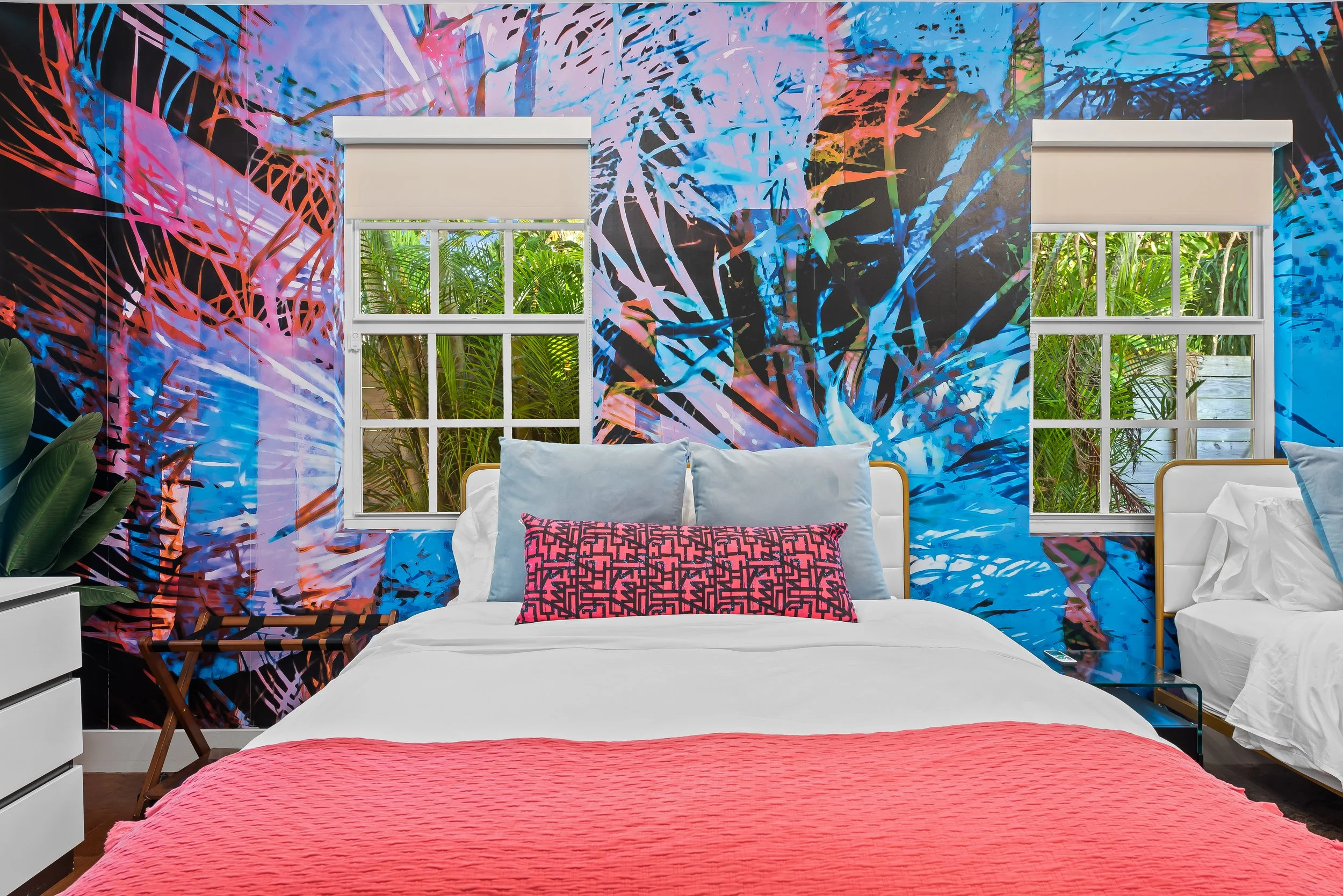 Jungle-mural bedroom with vibrant art and tropical views — Sun Haven Collection luxury vacation rental.