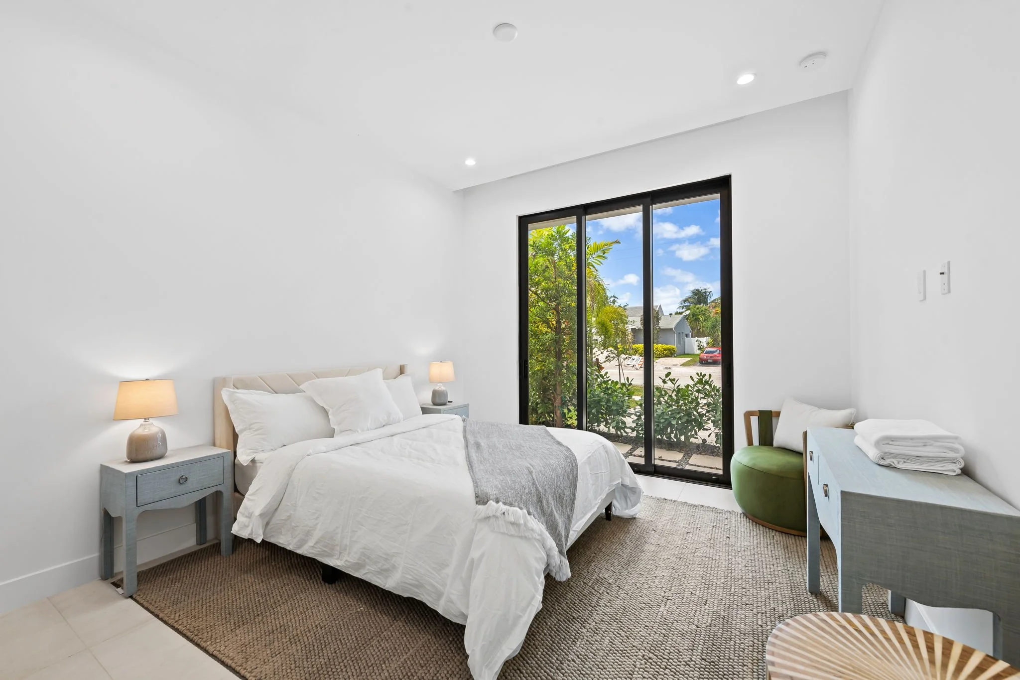 Guest bedroom with panoramic window views — Sun Haven Collection luxury vacation rental.