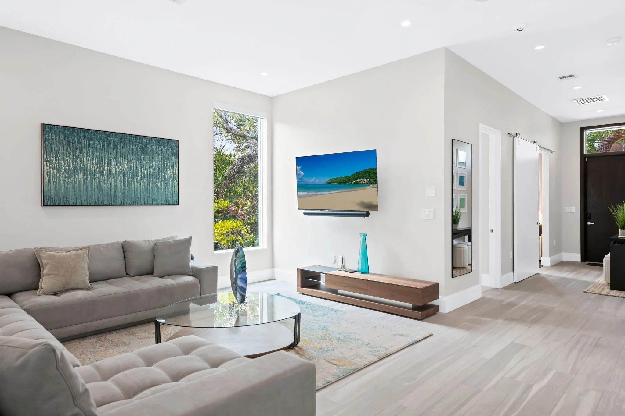 Living room with smart TV and garden views — Sun Haven Collection luxury vacation rental, Fort Lauderdale.