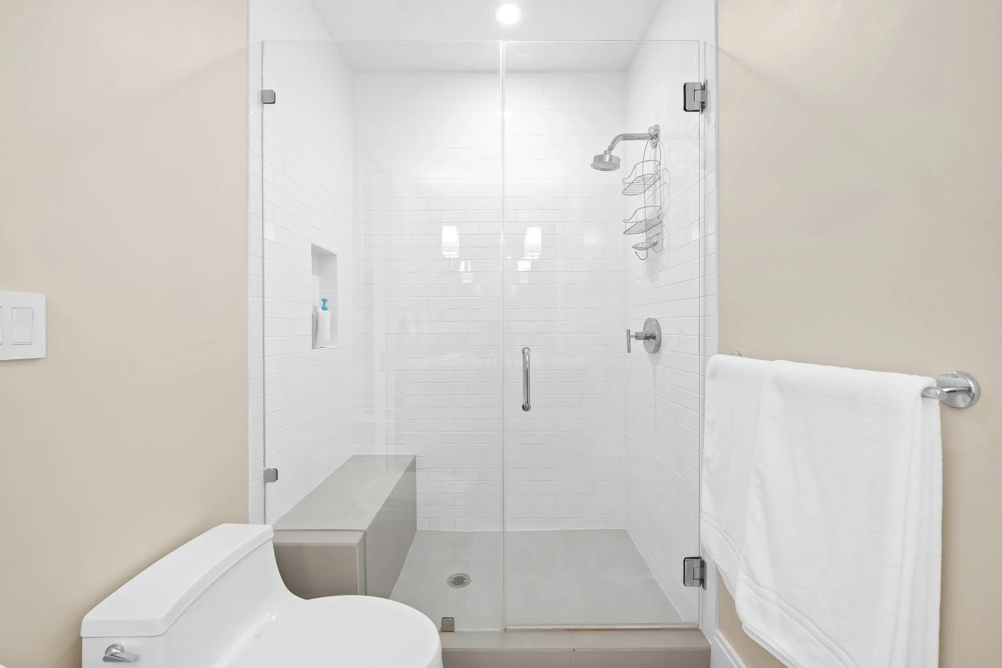 Modern glass-enclosed shower with premium bath products — Sun Haven Collection luxury vacation rental.